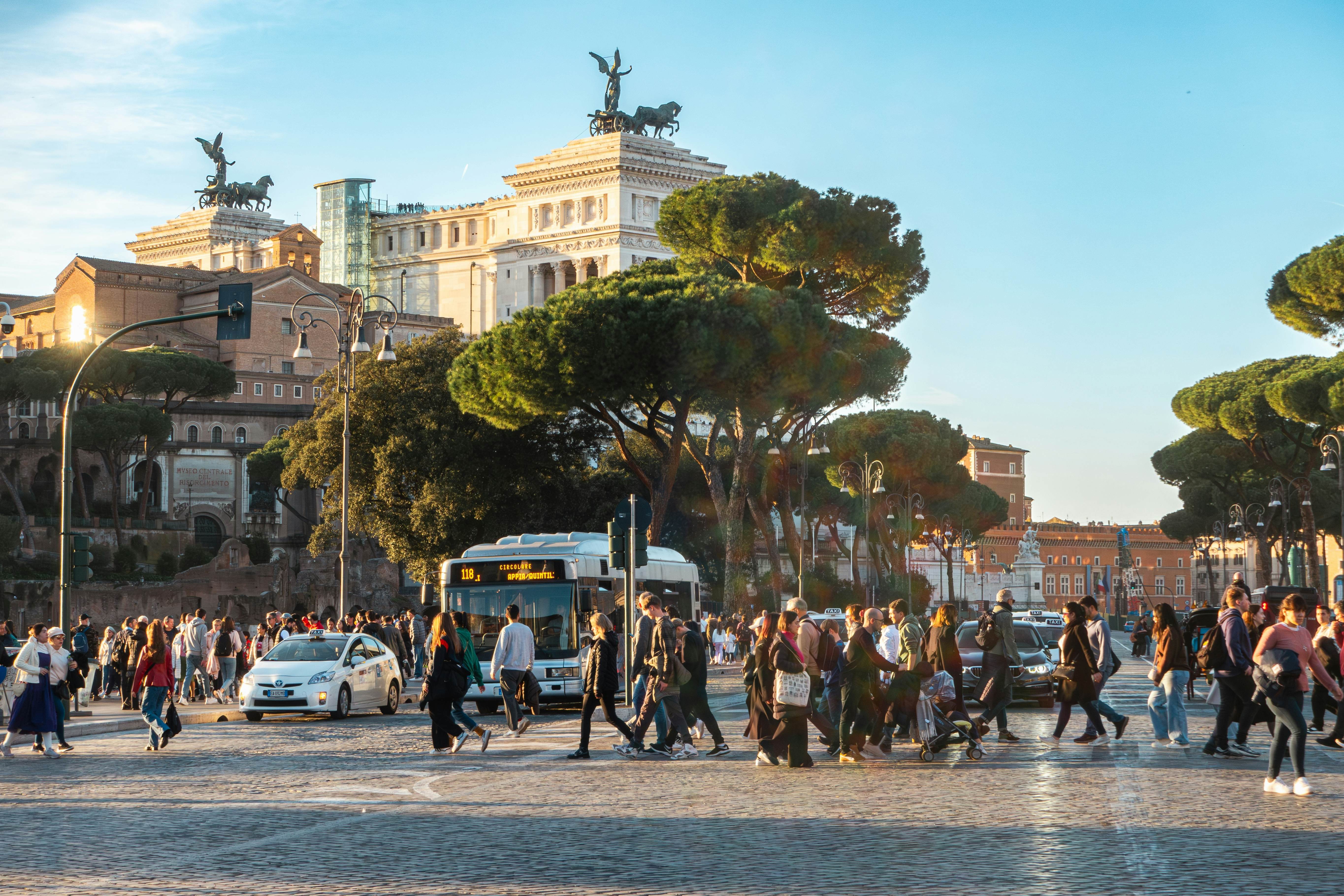 Rome, street with people, bus and taxis, Via dei Fori Imperiali with tourists (Imperial Forums street)
