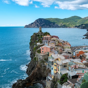 Vibrant houses cling to the cliffs of Cinque Terre, overlooking the sparkling turquoise waters. Lush green hills cradle this picturesque coastal village, Vernazza Italy, License Type: media, Download Time: 2025-07-01T16:25:54.000Z, User: katelyn.perry_lonelyplanet, Editorial: false, purchase_order: 65050 - Digital Destinations and Articles, job: wip, client: wip, other: Katelyn Perry