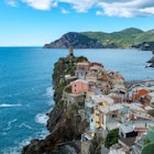 Vibrant houses cling to the cliffs of Cinque Terre, overlooking the sparkling turquoise waters. Lush green hills cradle this picturesque coastal village, Vernazza Italy, License Type: media, Download Time: 2025-07-01T16:25:54.000Z, User: katelyn.perry_lonelyplanet, Editorial: false, purchase_order: 65050 - Digital Destinations and Articles, job: wip, client: wip, other: Katelyn Perry