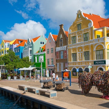 CURACAO - NOV. 30, 2024: Historic waterfront commercial houses with Dutch style on Handelskade Street in Punda, Willemstad, Curacao. Historic Willemstad is a UNESCO World Heritage Site. , License Type: media, Download Time: 2025-07-15T18:04:44.000Z, User: dorota_littlerobindesign, Editorial: true, purchase_order: 56530 - Guidebooks, job: Global Publishing WIP, client: Experience Aruba 1, other: Dorota Michalec