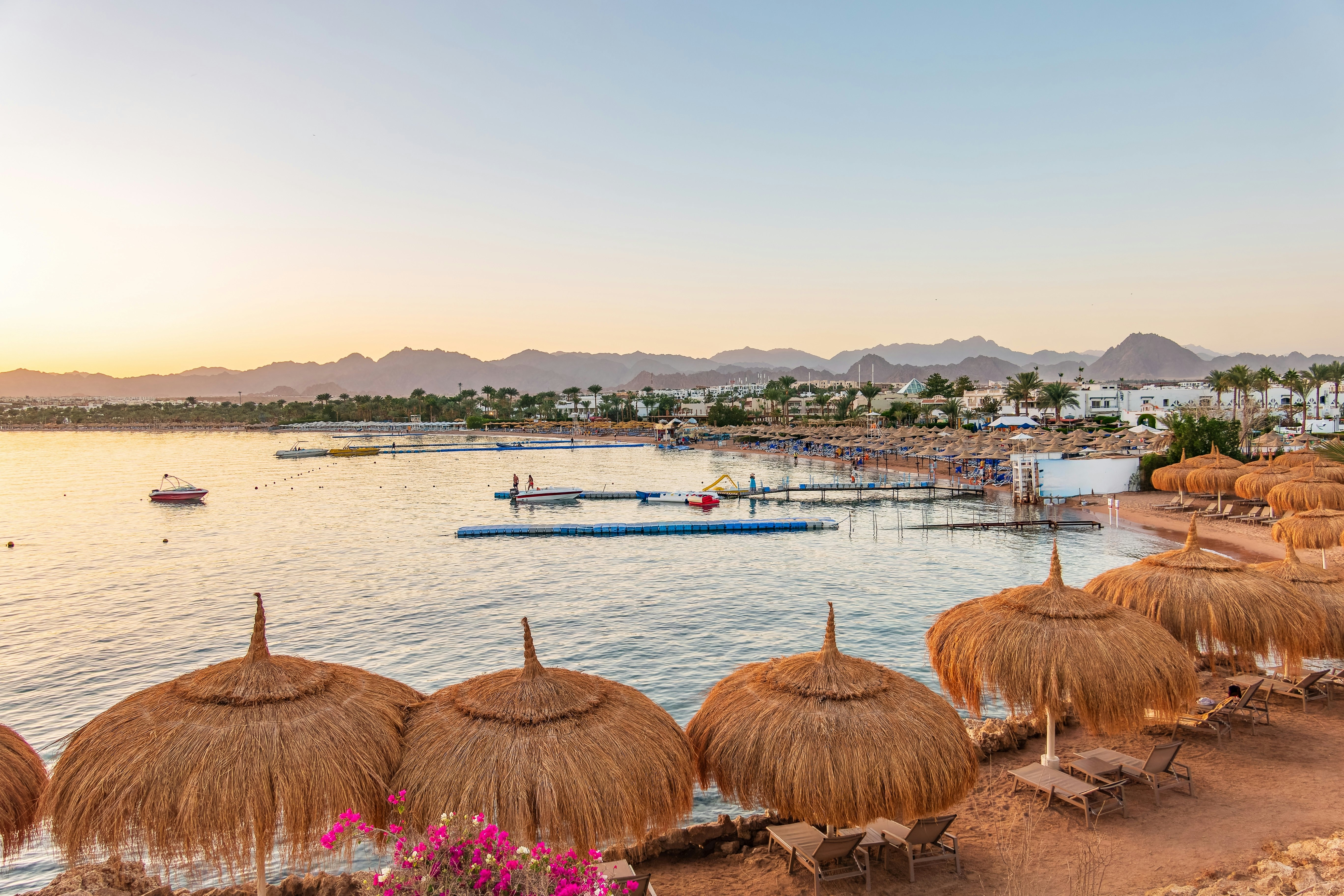 A line of grass sun umbrellas at Naama Bay, Sharm-el-Sheikh, Egypt.