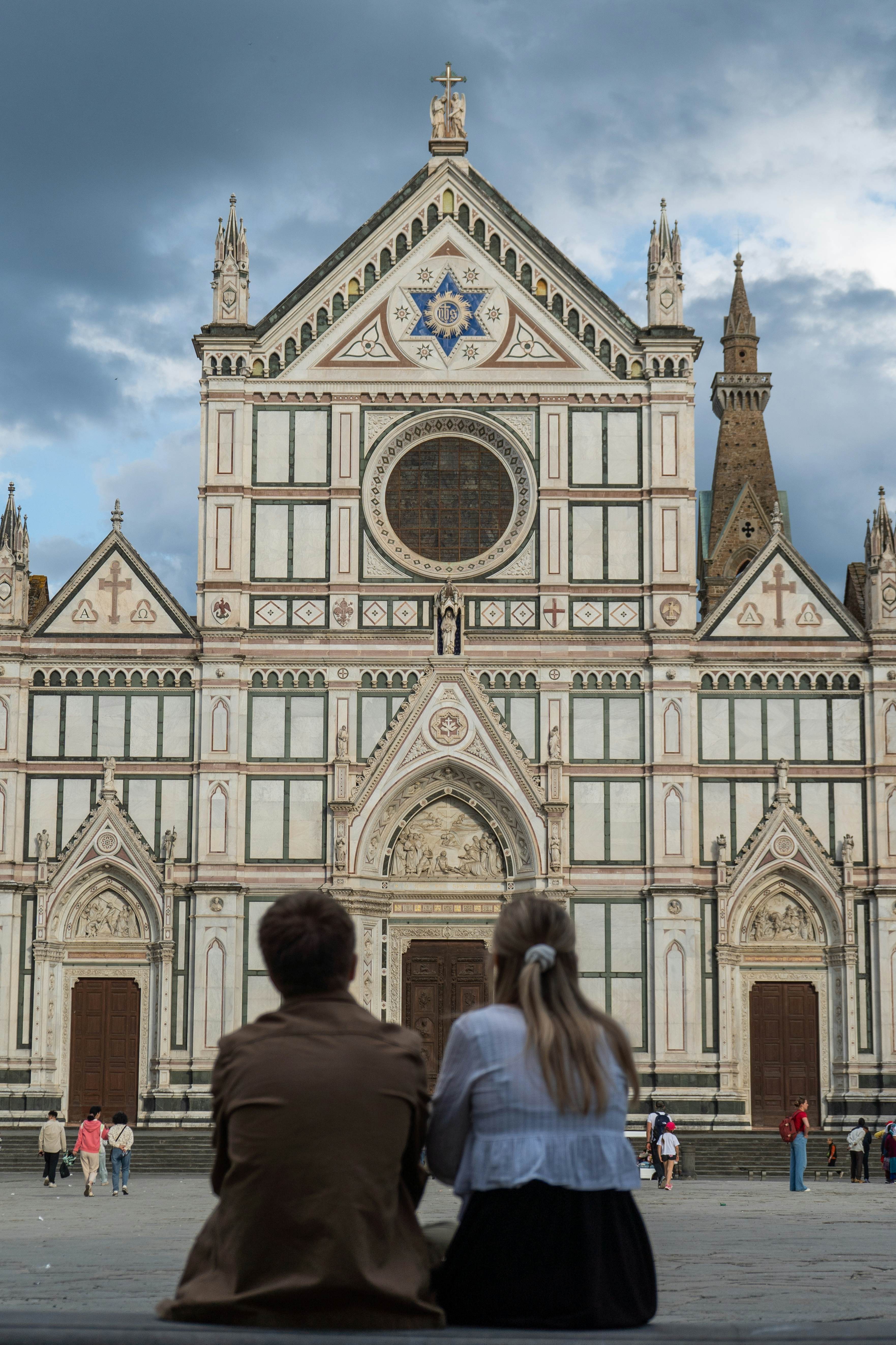 People look up at the Basilica di Santa Croce, Florence.