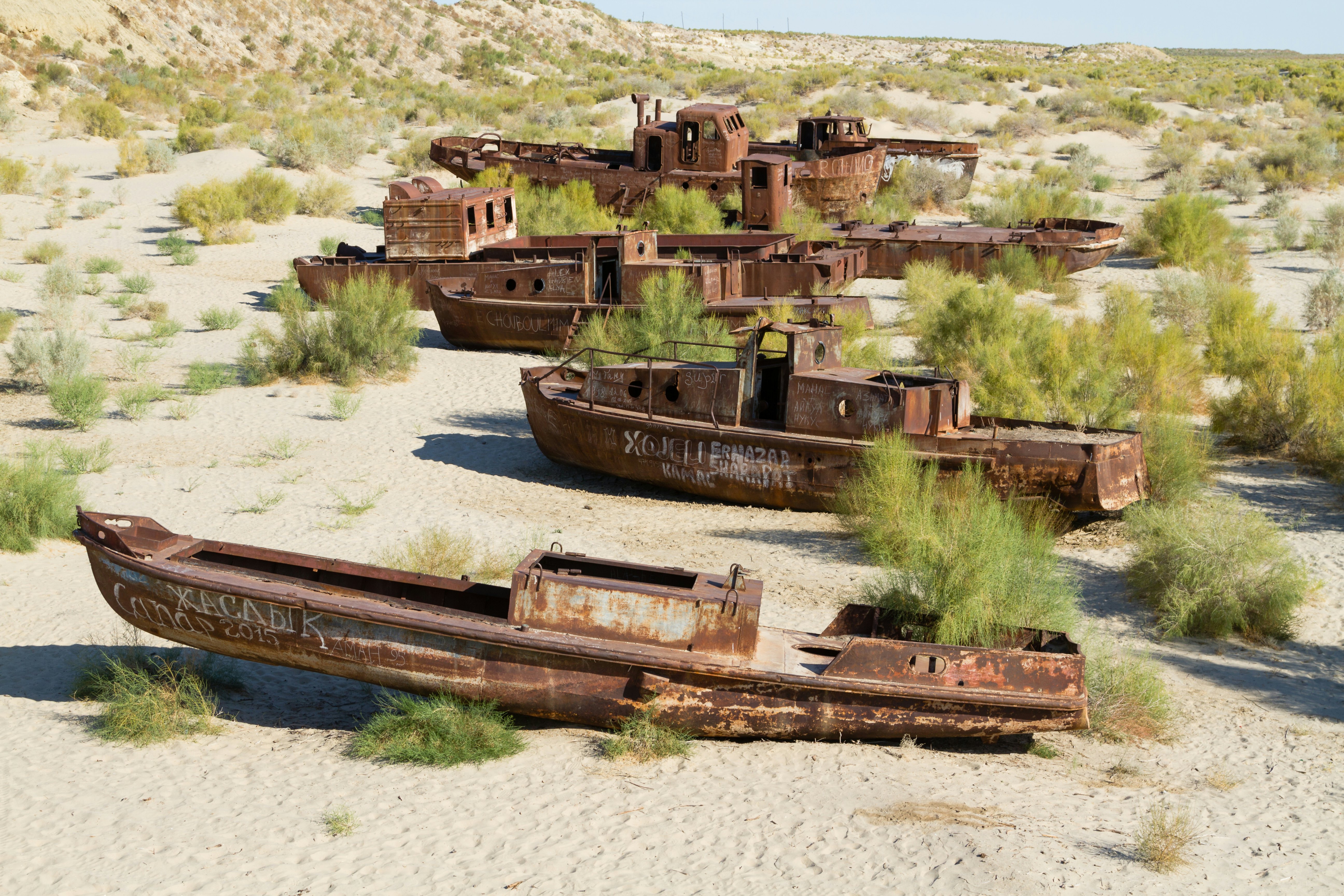 Rusty boats in a ship graveyard in the desert in the Aral Sea in Uzbekistan.