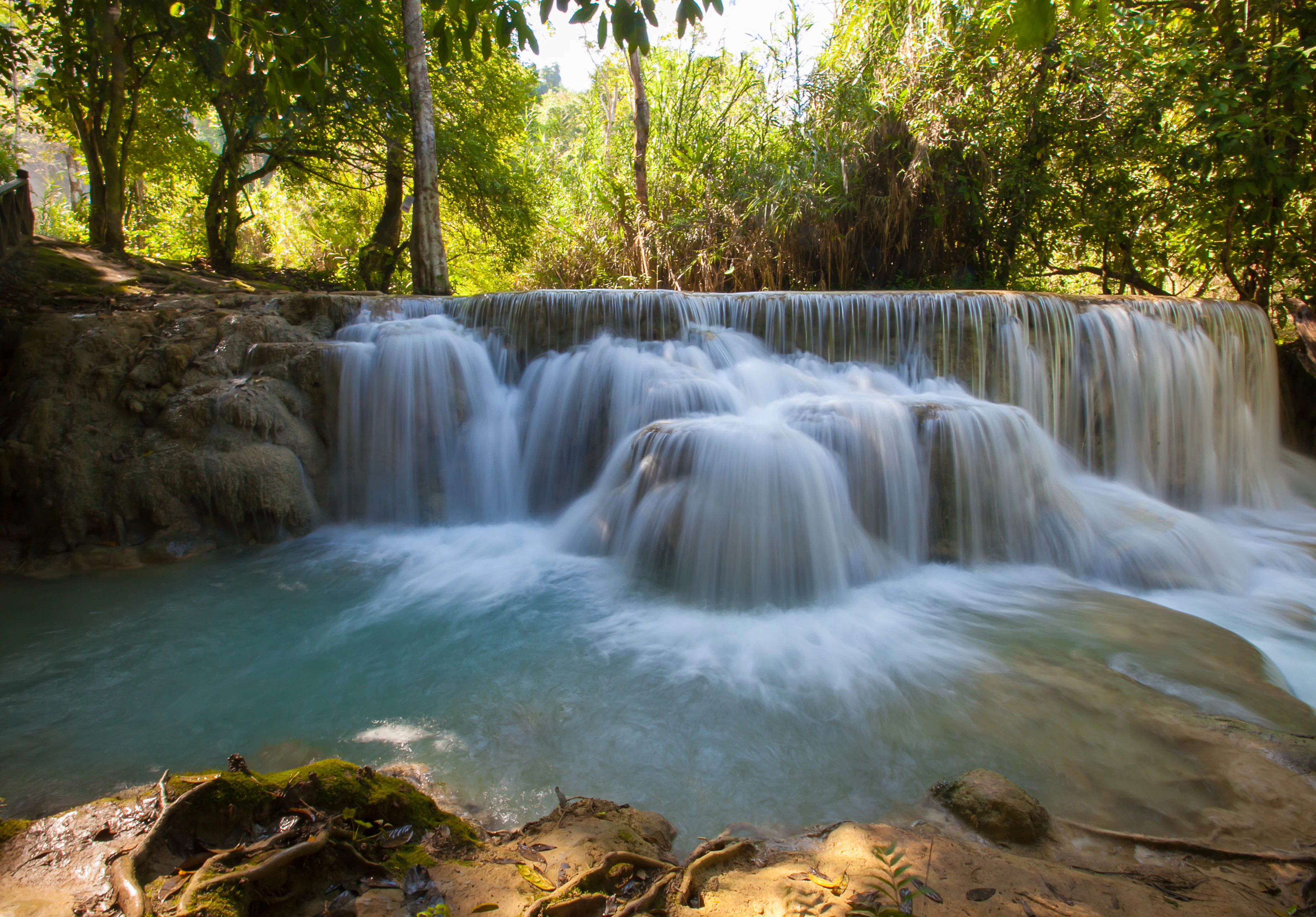 A multi-level waterfall in a forest.