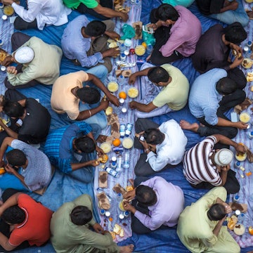 Communal charity iftar organised on a street by a local mosque. Dubai, UAE - 22/JUL/2016, License Type: media, Download Time: 2025-11-12T17:28:27.000Z, User: bhealy950, Editorial: true, purchase_order: 65050 - Digital Destinations and Articles, job: Lonely Planet Online Editorial, client: Dubai in Ramadan, other: Brian Healy