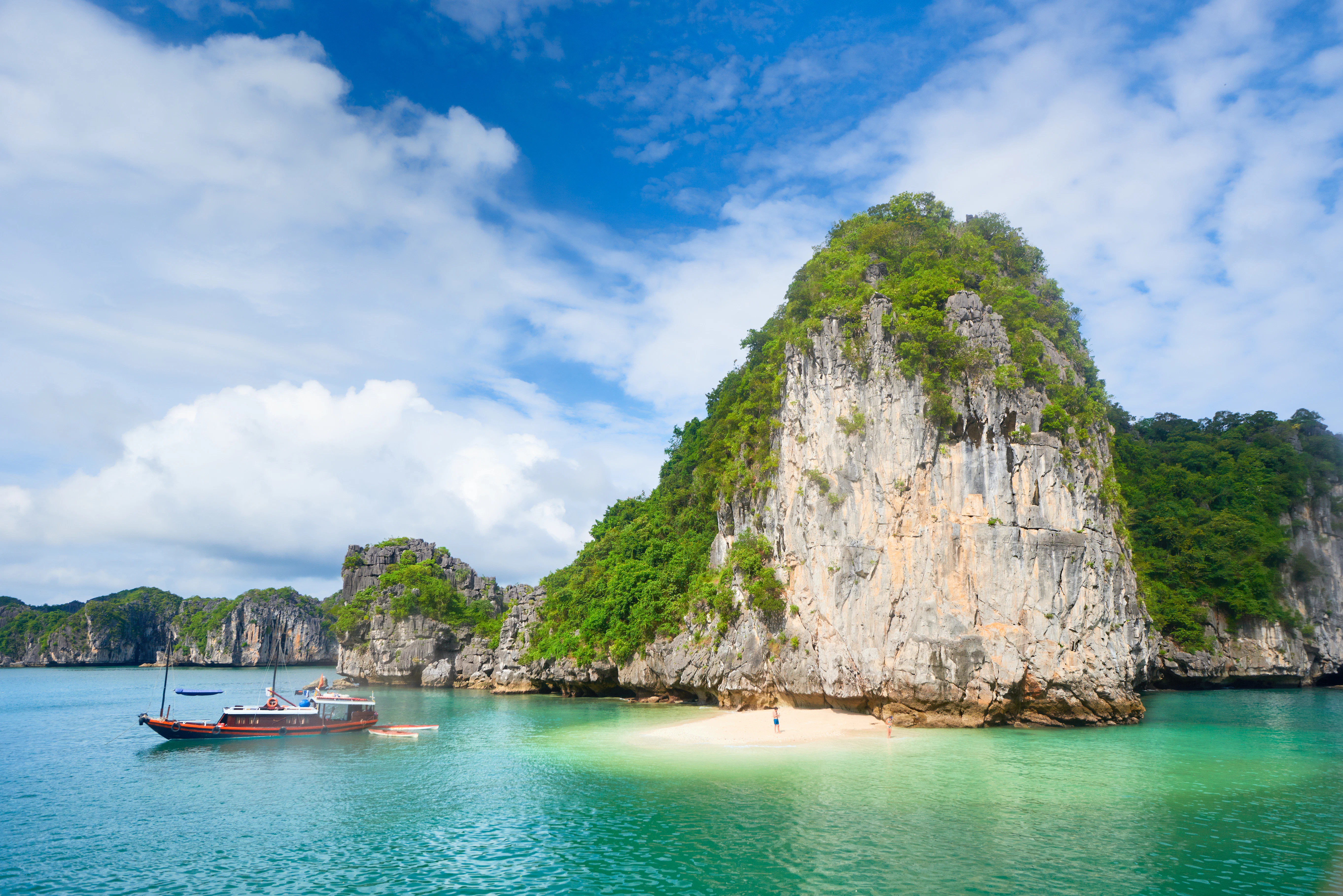 an island and a small beach with a boat