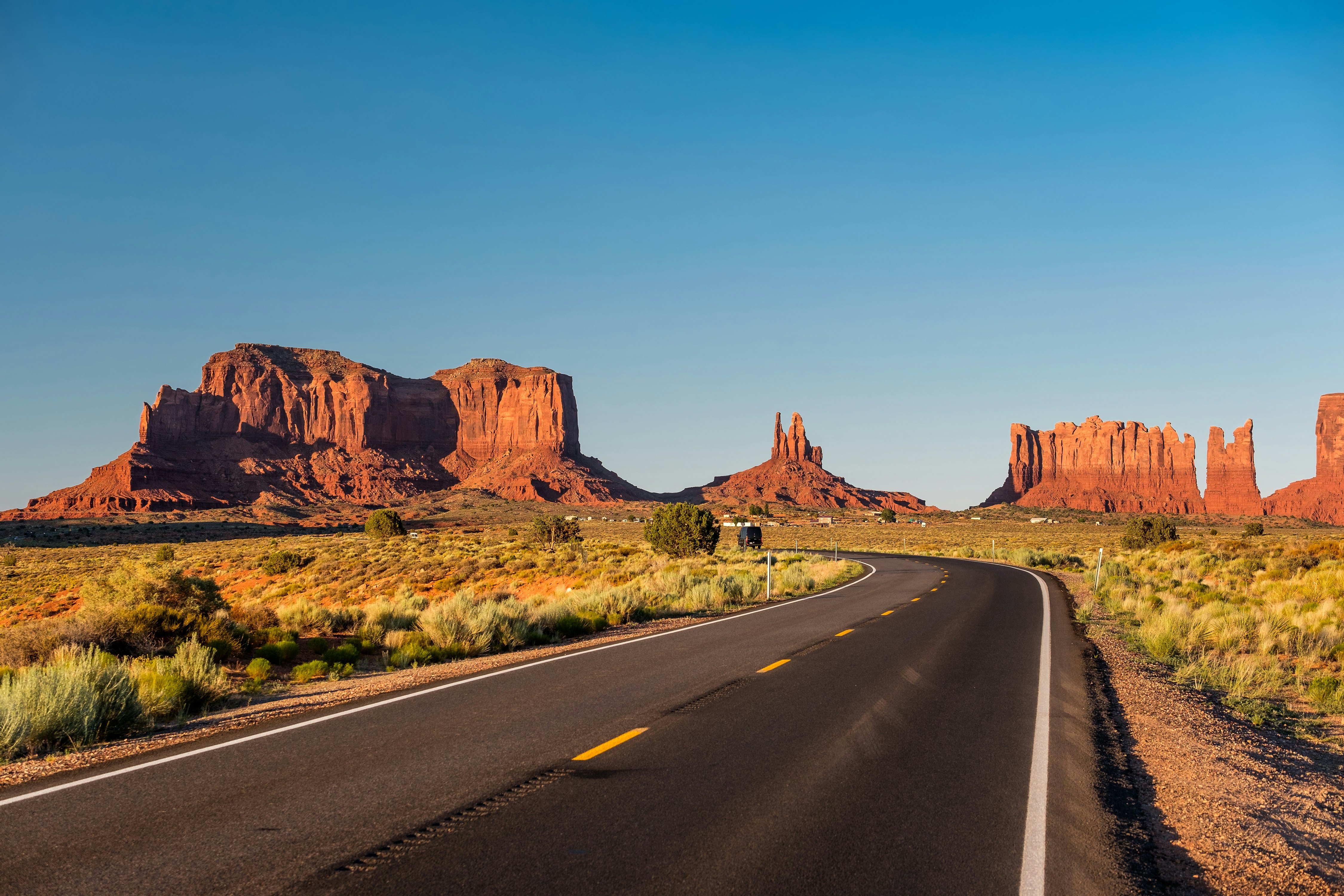 Empty scenic highway with monuments in the background