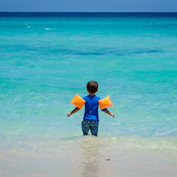 Young child wearing floaties at a Cuban beach.
1142828405
active, beach, boy, cheerful, child, coast, cuba, cuban beach, cute, family, family fun, family travel, family trip, fun, happy, holiday, joy, kid, little, nature, ocean, outdoor, sand, sea, summer, travel, tropical, turquoise, turquoise beach vacations, turquoise water, vacation, water, young