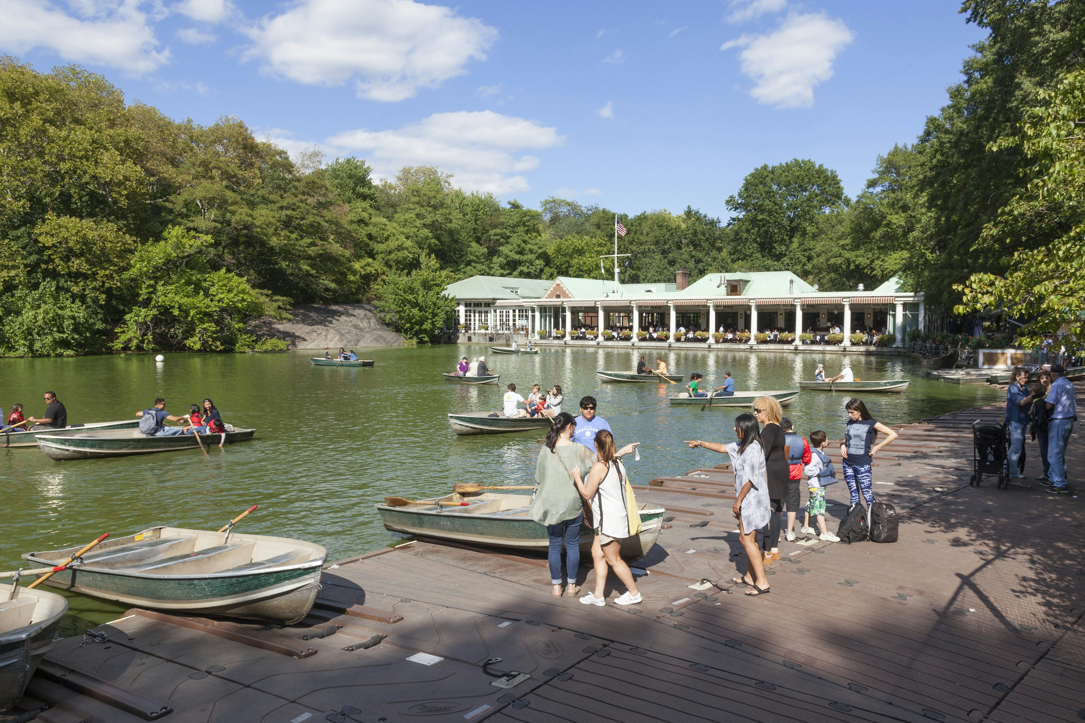 Visitors row in boats in a Central Park pond near the Central Park Boathouse.