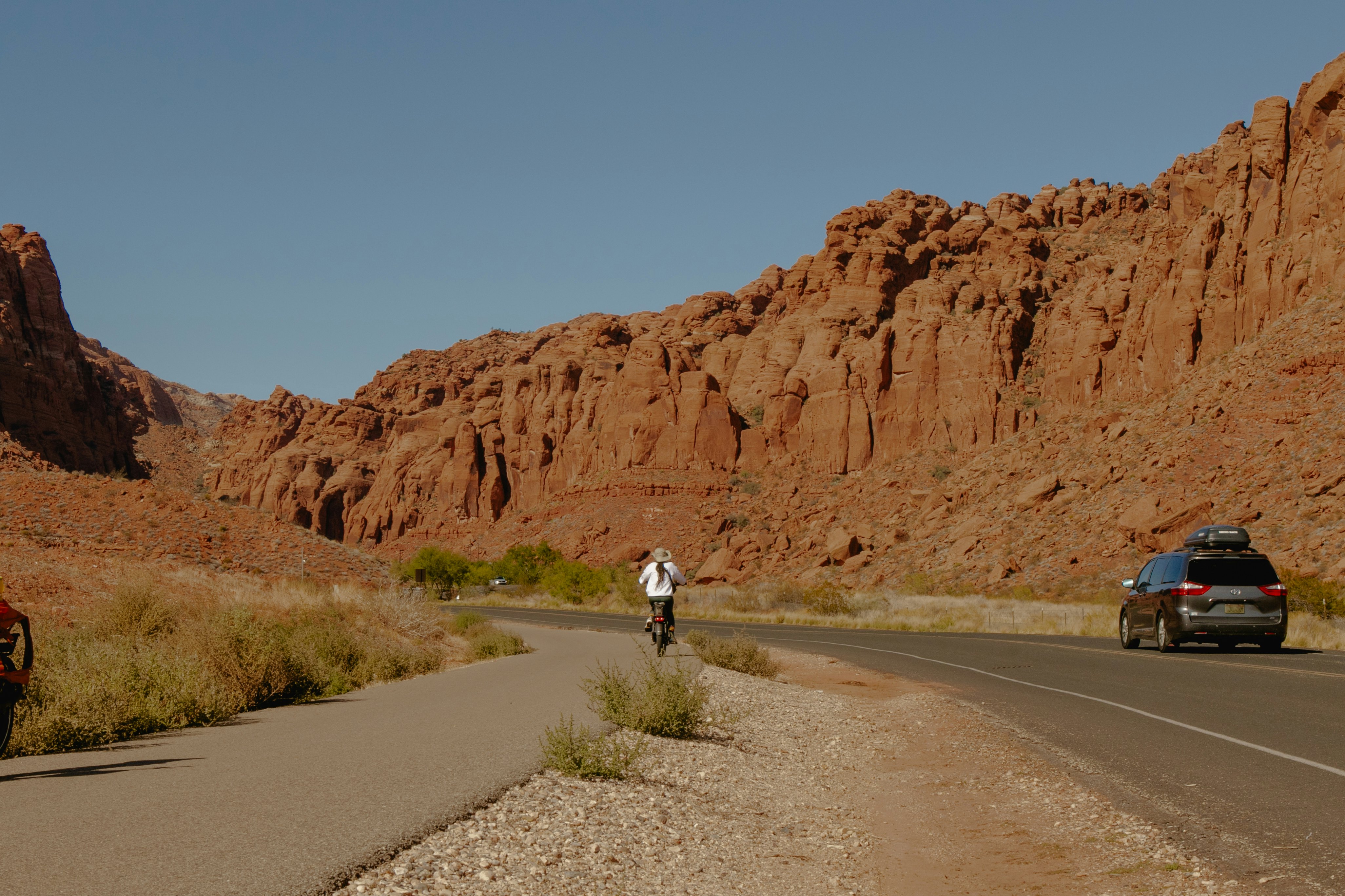 Woman biking in Utah alongside natural rock formations