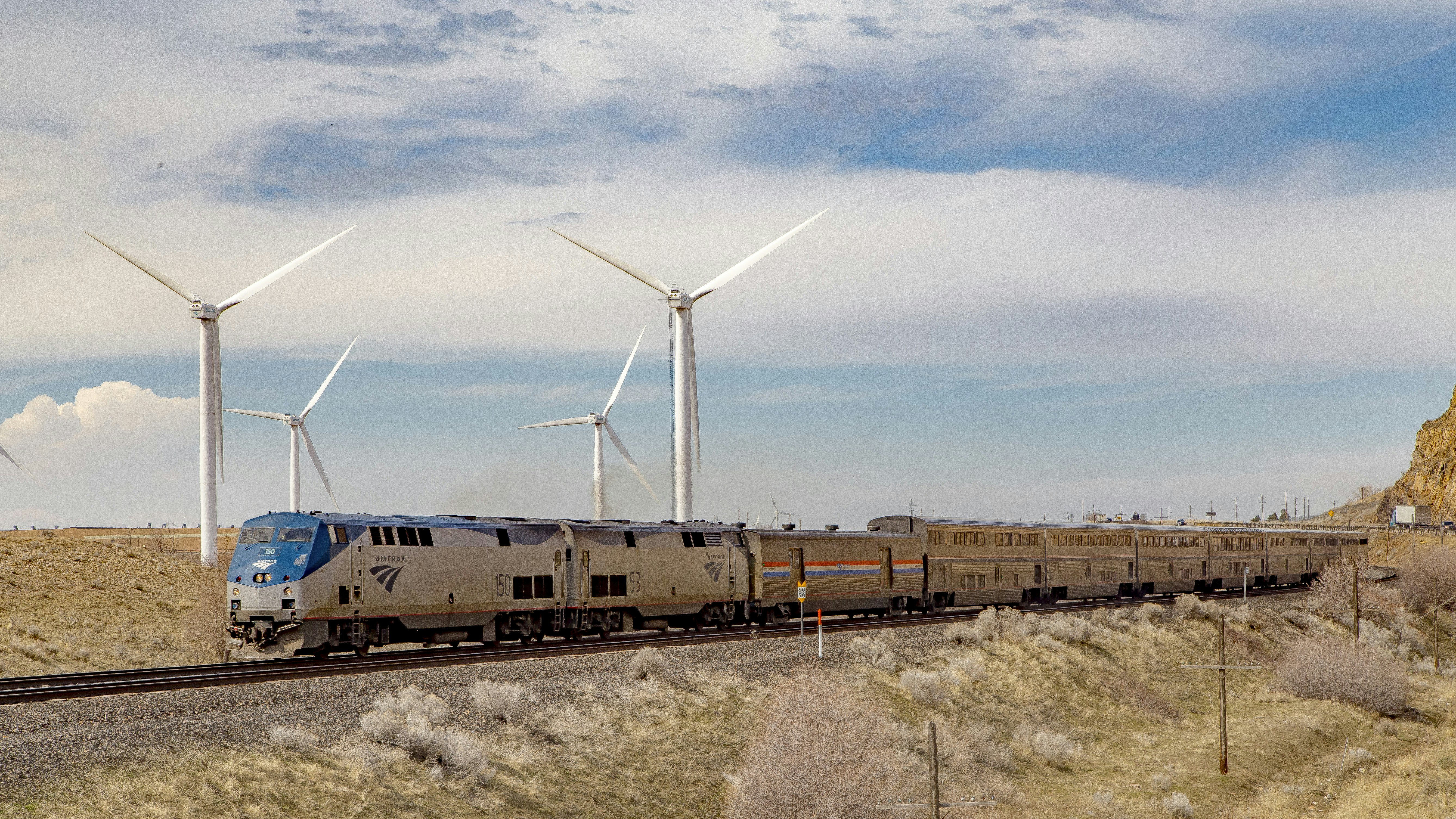 A train passing over raised tracks by wind