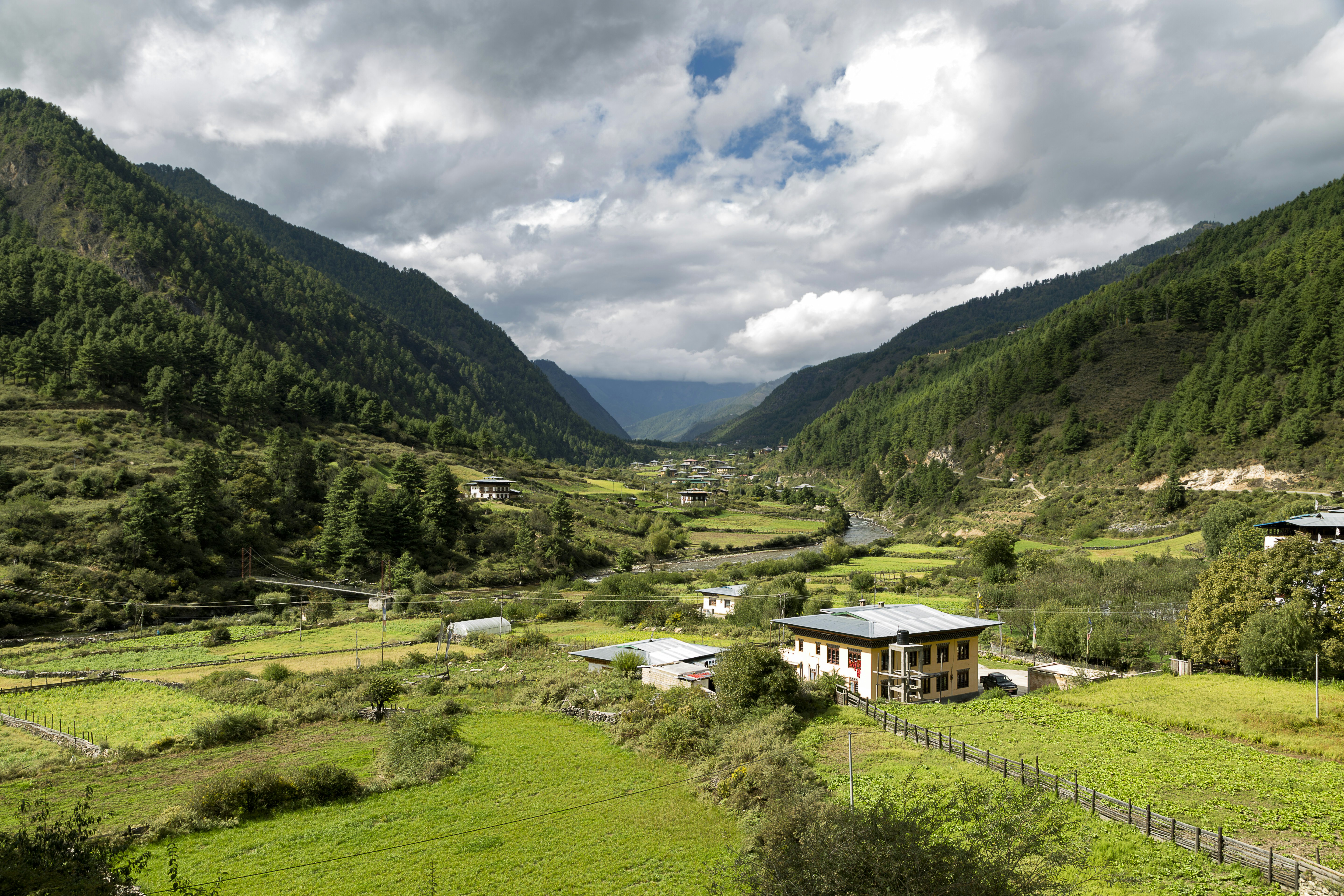 A valley surrounded by lush green mountains.