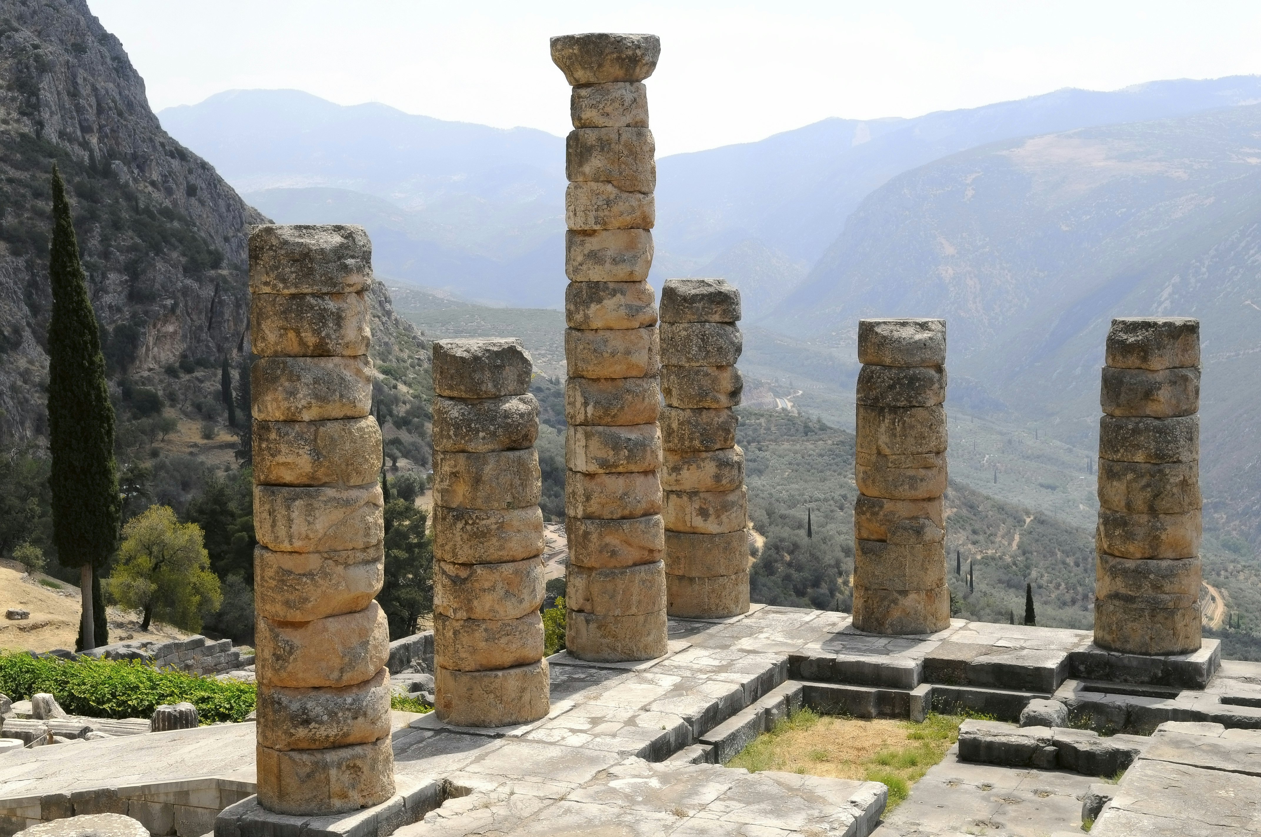 Ruined columns at a temple in a mountainous region.