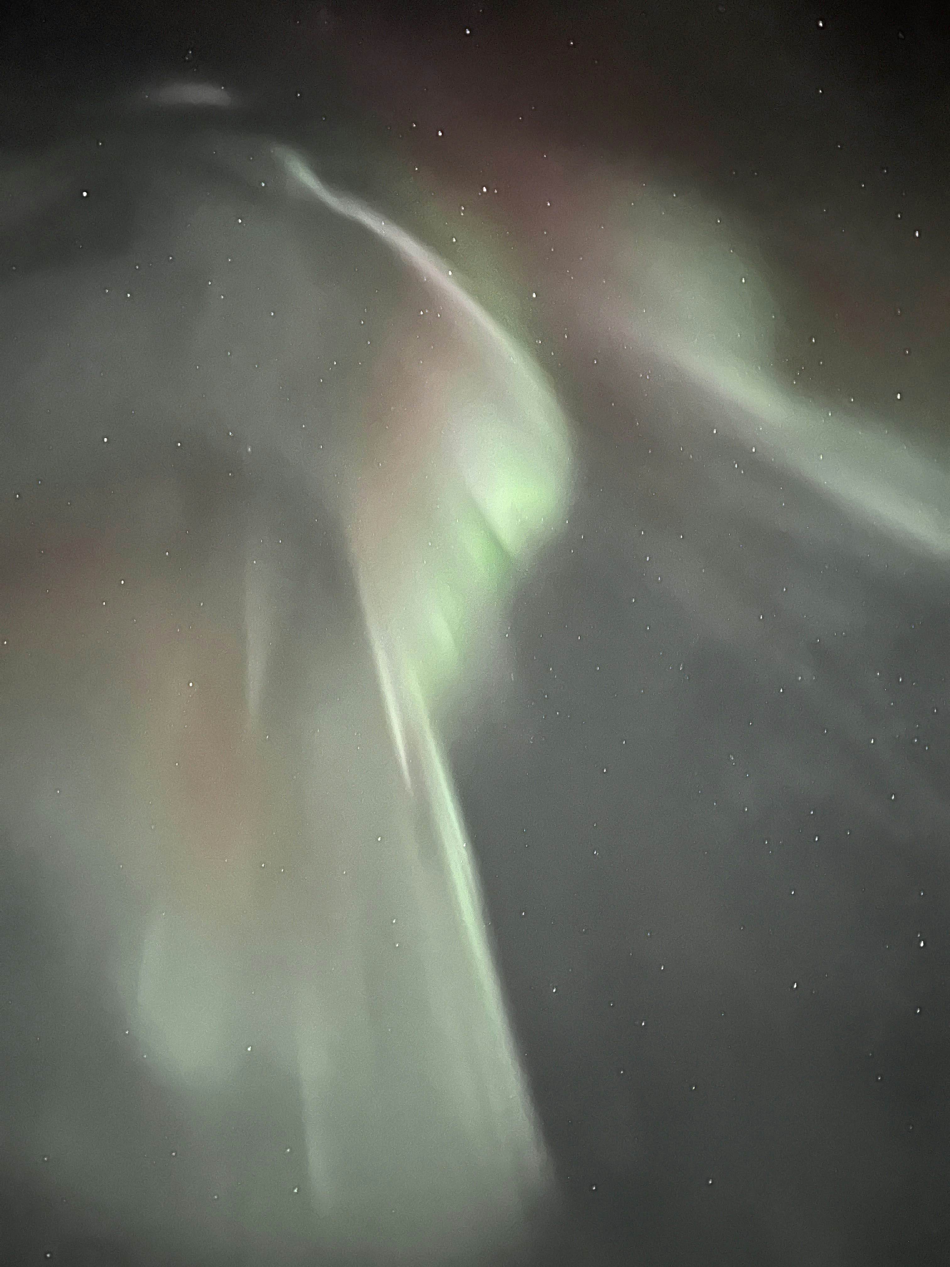 Swirls of white against a dark starry sky in Alaska.