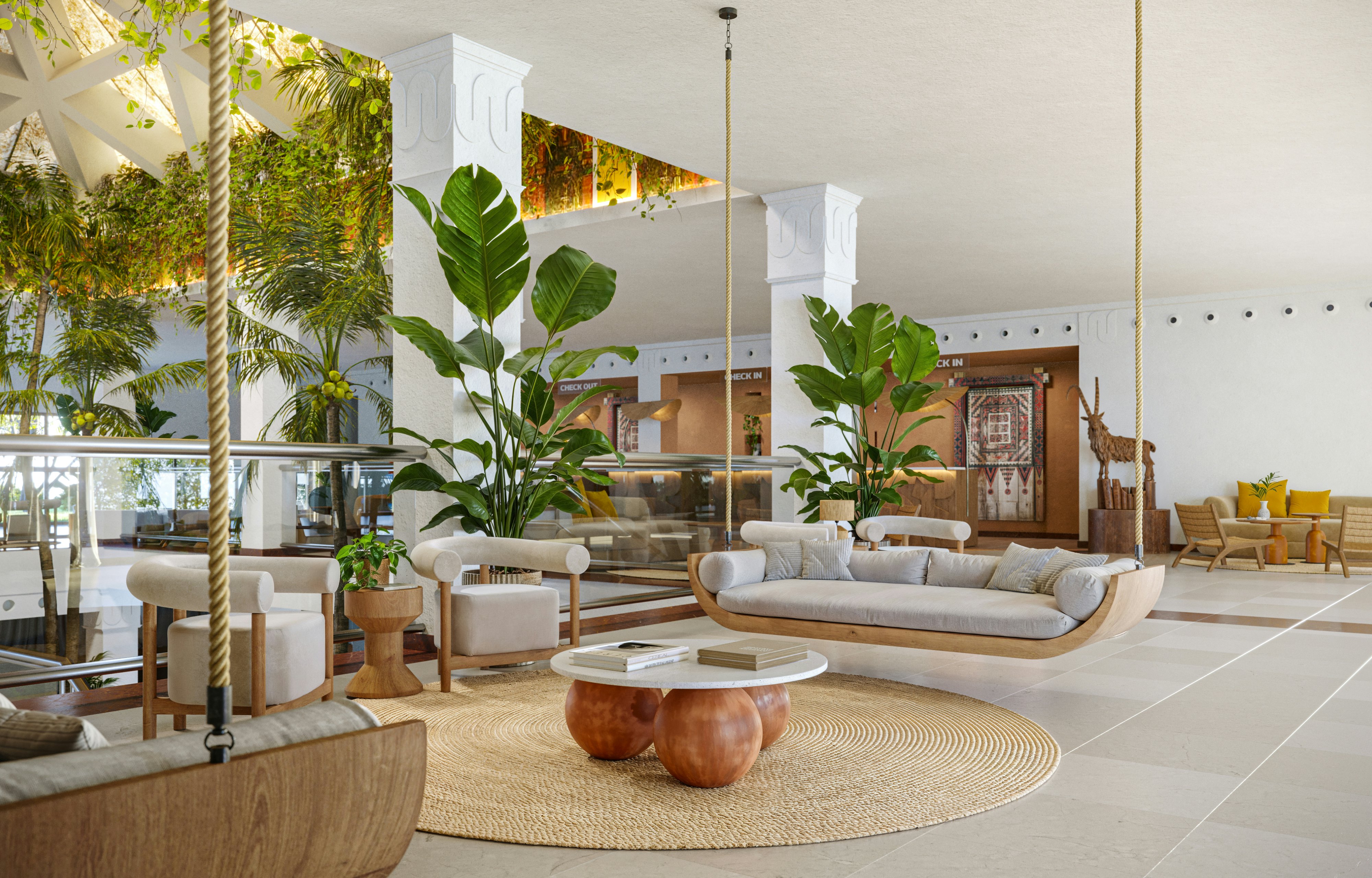 The relaxed lobby of the Iberostar Selection hotel in Fuerteventura with rattan furniture, greenery and neutral tiled floors.