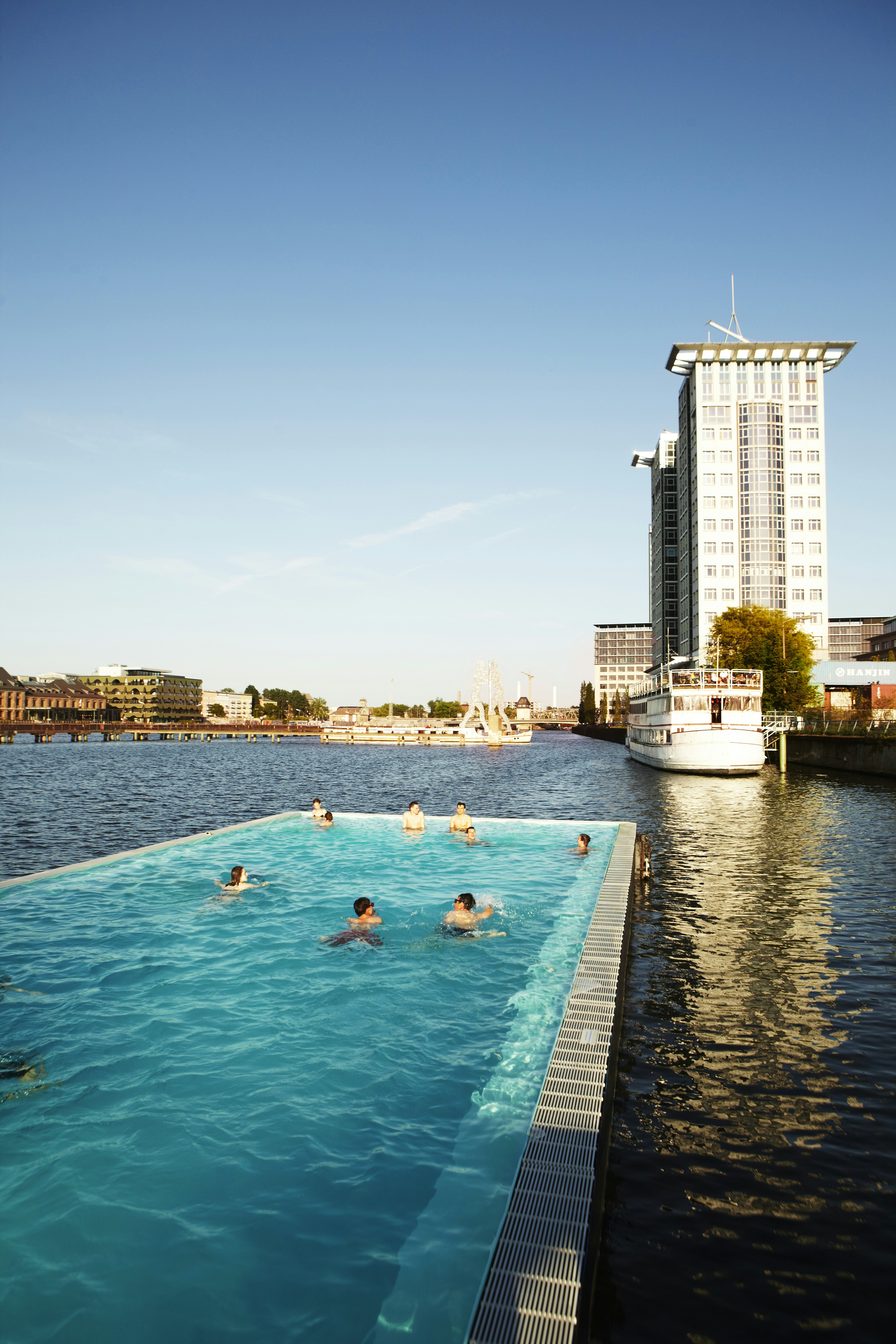 People swim at Badeschiff swimming barge on River Spree.