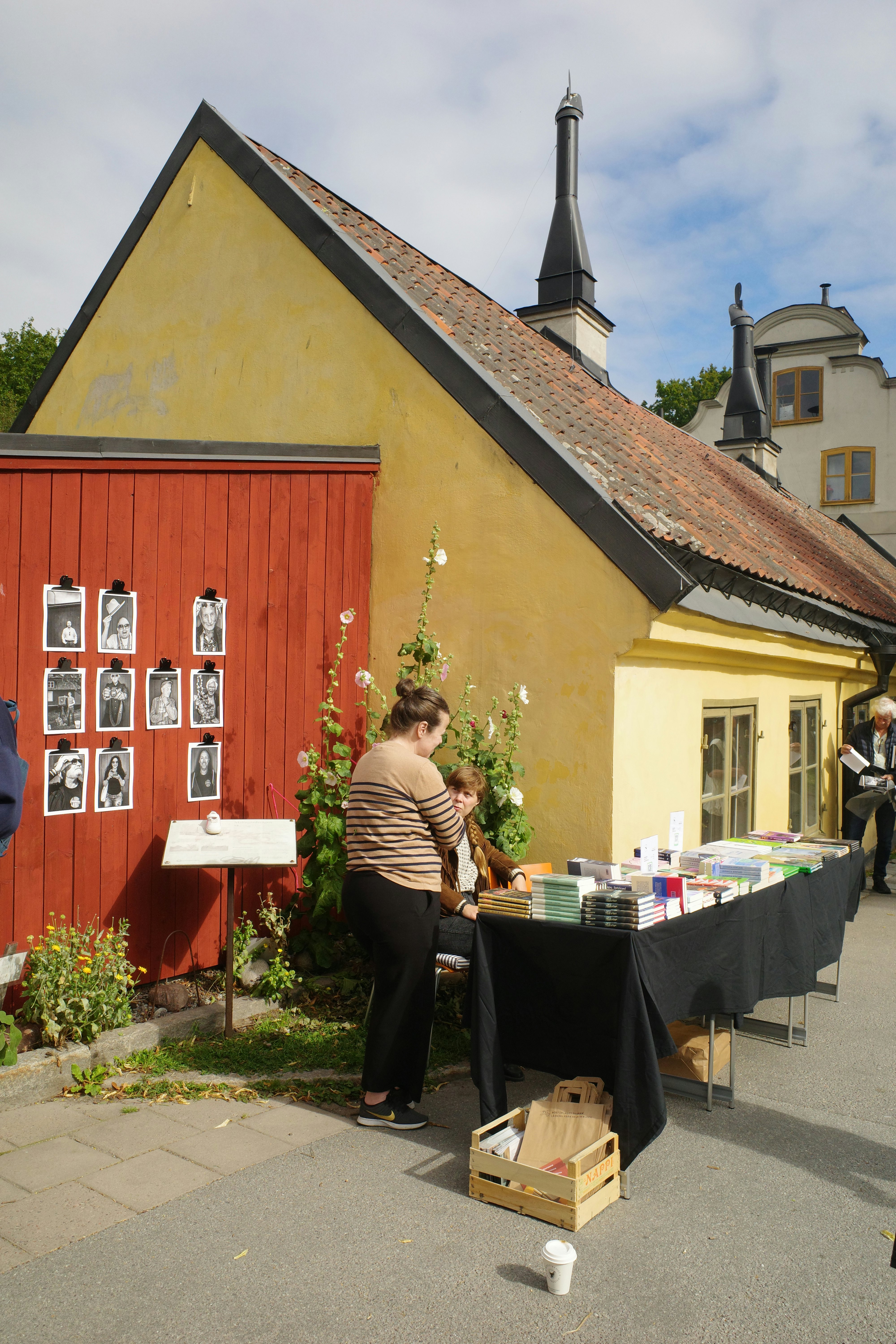 Photographers and vendors selling prints and pottery outside of Vasaparken in Stockholm.