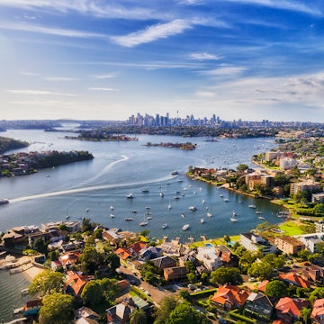 Sydney inner west suburb Drummoyne and beyond on shores of Parramatta river flowing into Sydney harbour with distant city CBD on horizon in elevated aerial view. License Type: media Download Time: 2022-02-28T15:12:11.000Z User: Is Editorial: No purchase_order: