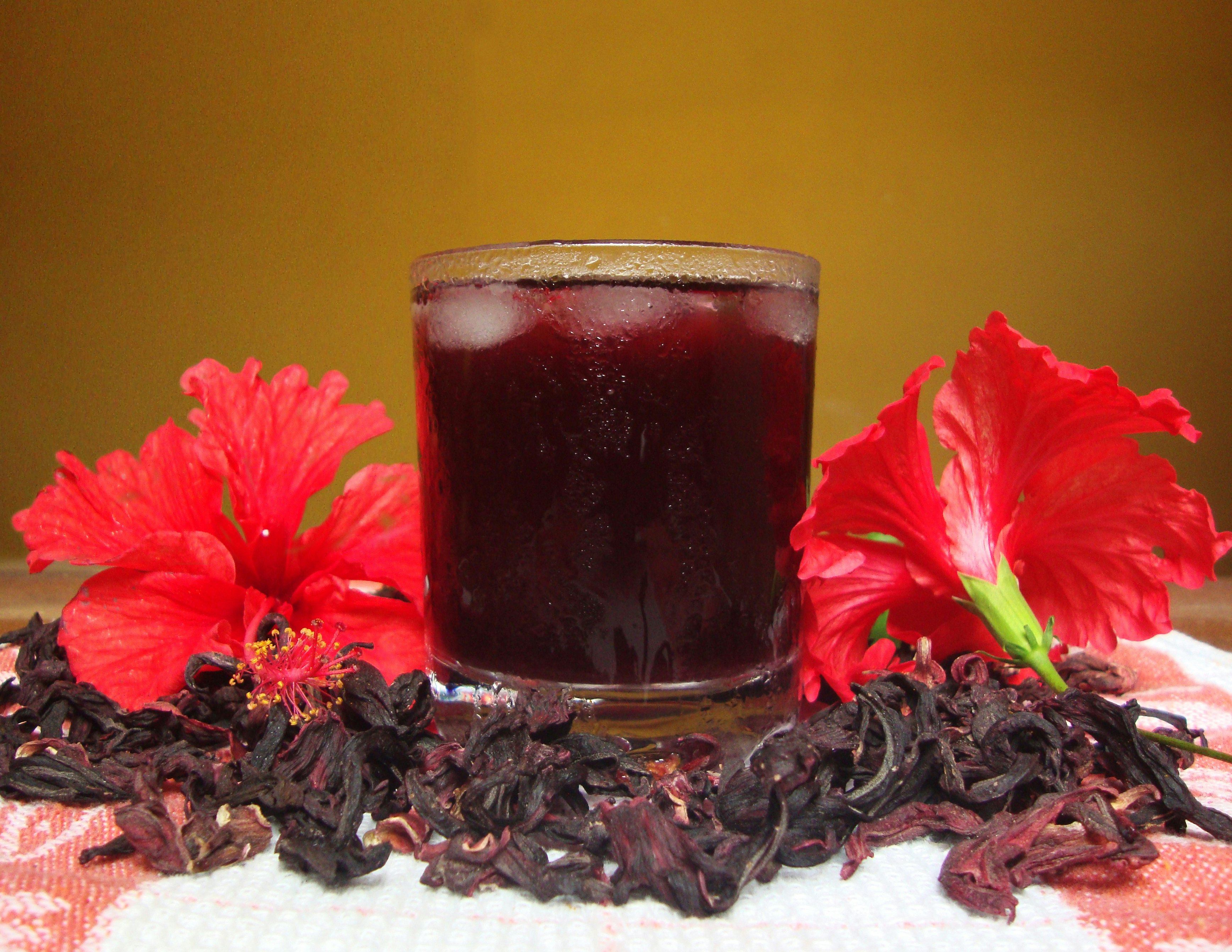 Hibiscus flower tea in a glass with ice