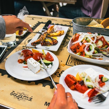 Thessaloniki, Greece - May 27, 2015: Delicious dinner at The Malamatina Cafe in Thessaloniki. A large portion of Greek salad, grilled octopus and bread. Greece License Type: media Download Time: 2023-01-11T03:31:45.000Z User: aomi.ito_lonelyplanet Is Editorial: Yes purchase_order: