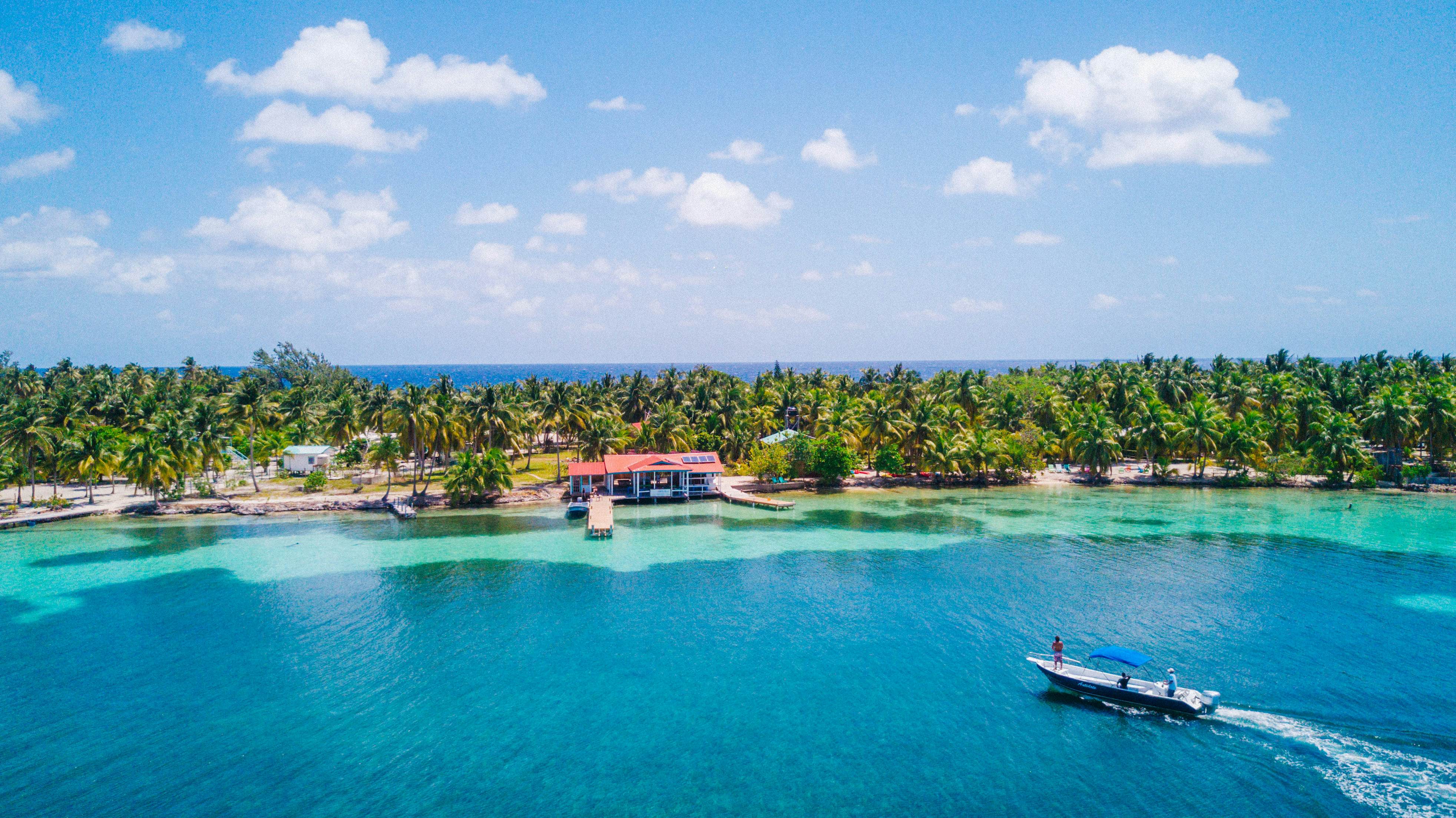 Aerial photo of tropical island South Water Caye  in Belize with boat docking  License Type: media  Download Time: 2023-07-20T20:51:34.000Z  User: Norma.PrauseBrewer_LonelyPlanet  Is Editorial: No  purchase_order: