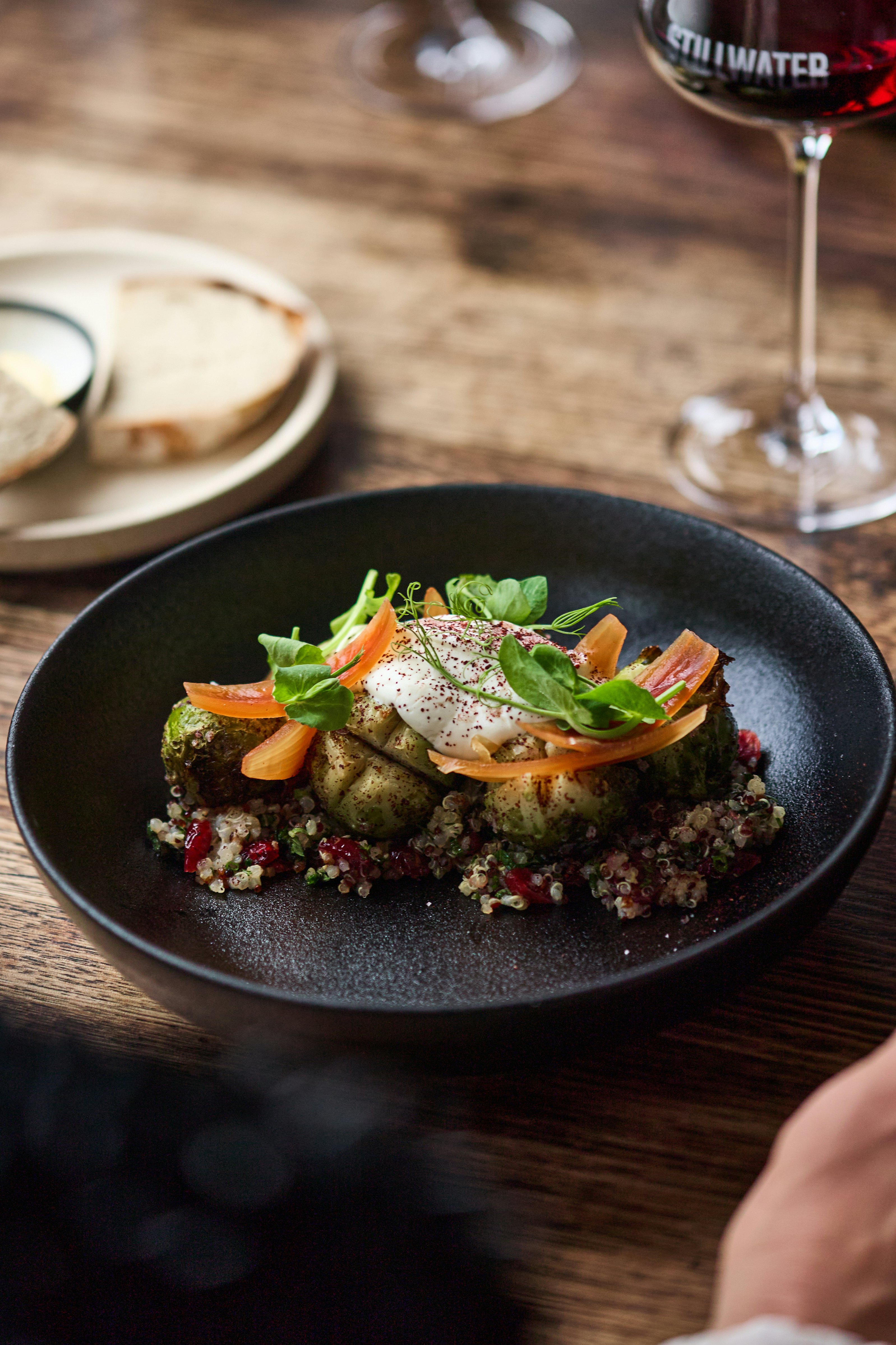 Grains and greens on black bowl