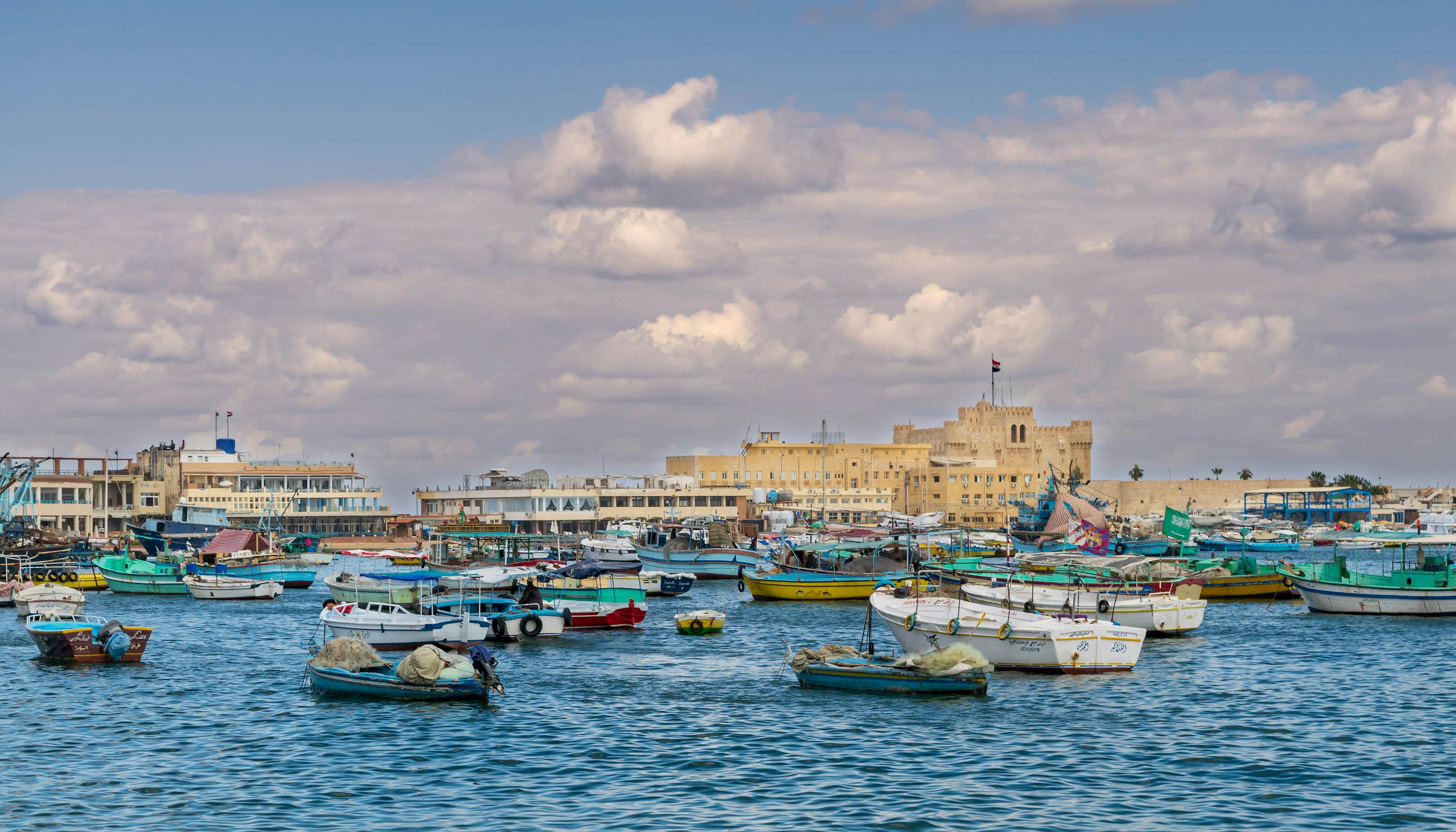 Alexandria, Egypt - December 3 2015: Old east harbor of Alexandria city at the Mediterranean Sea with fishing boats in the foreground and the Citadel of Qaitbay in the background in cloudy winter day, License Type: media, Download Time: 2025-06-20T13:09:59.000Z, User: oneseven7891, Editorial: true, purchase_order: 56530 - Guidebooks, job: Global Publishing WIP, client: Experience Egypt 1, other: Dominic Allen