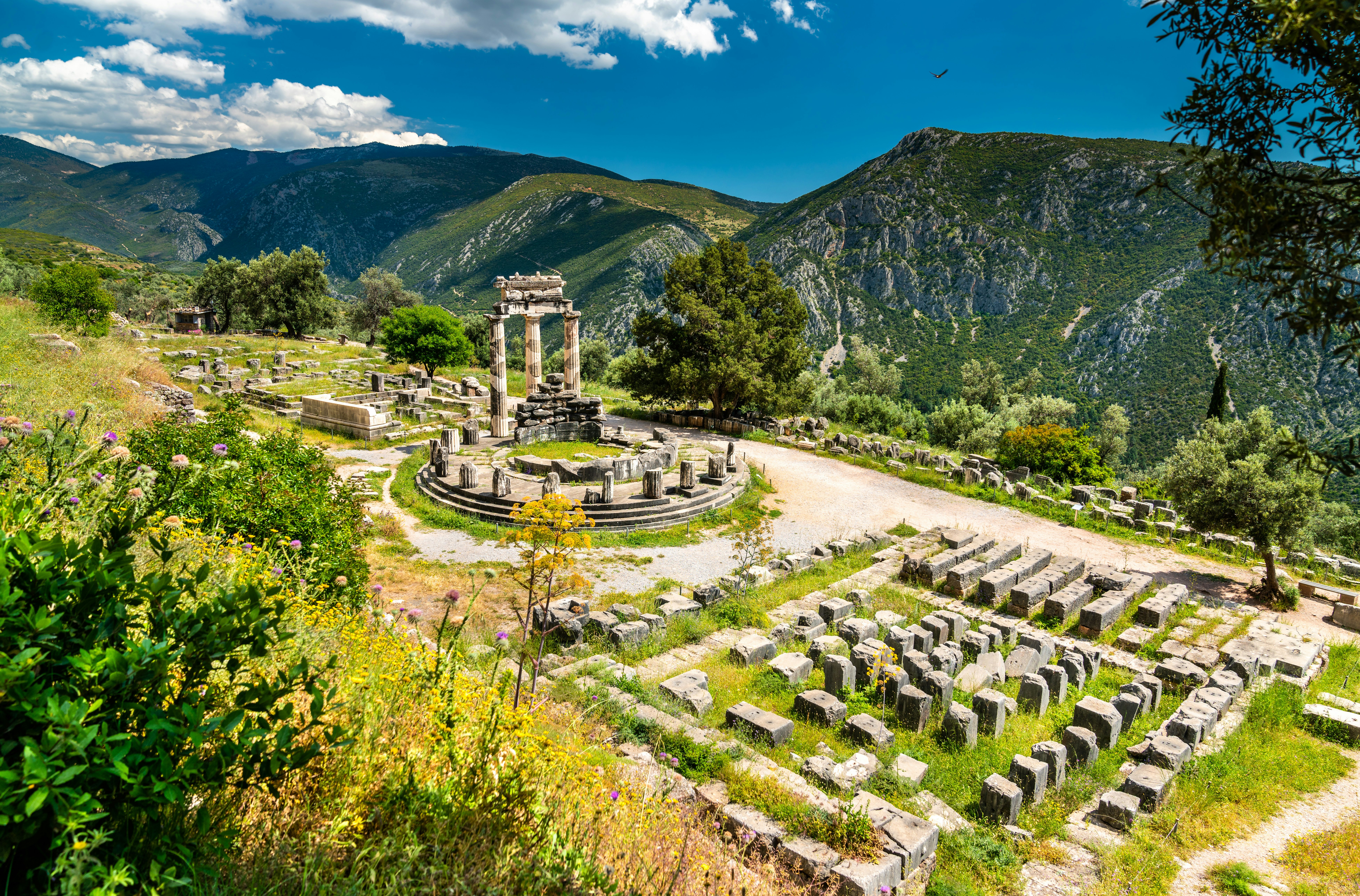 A temple and ruins in a green valley