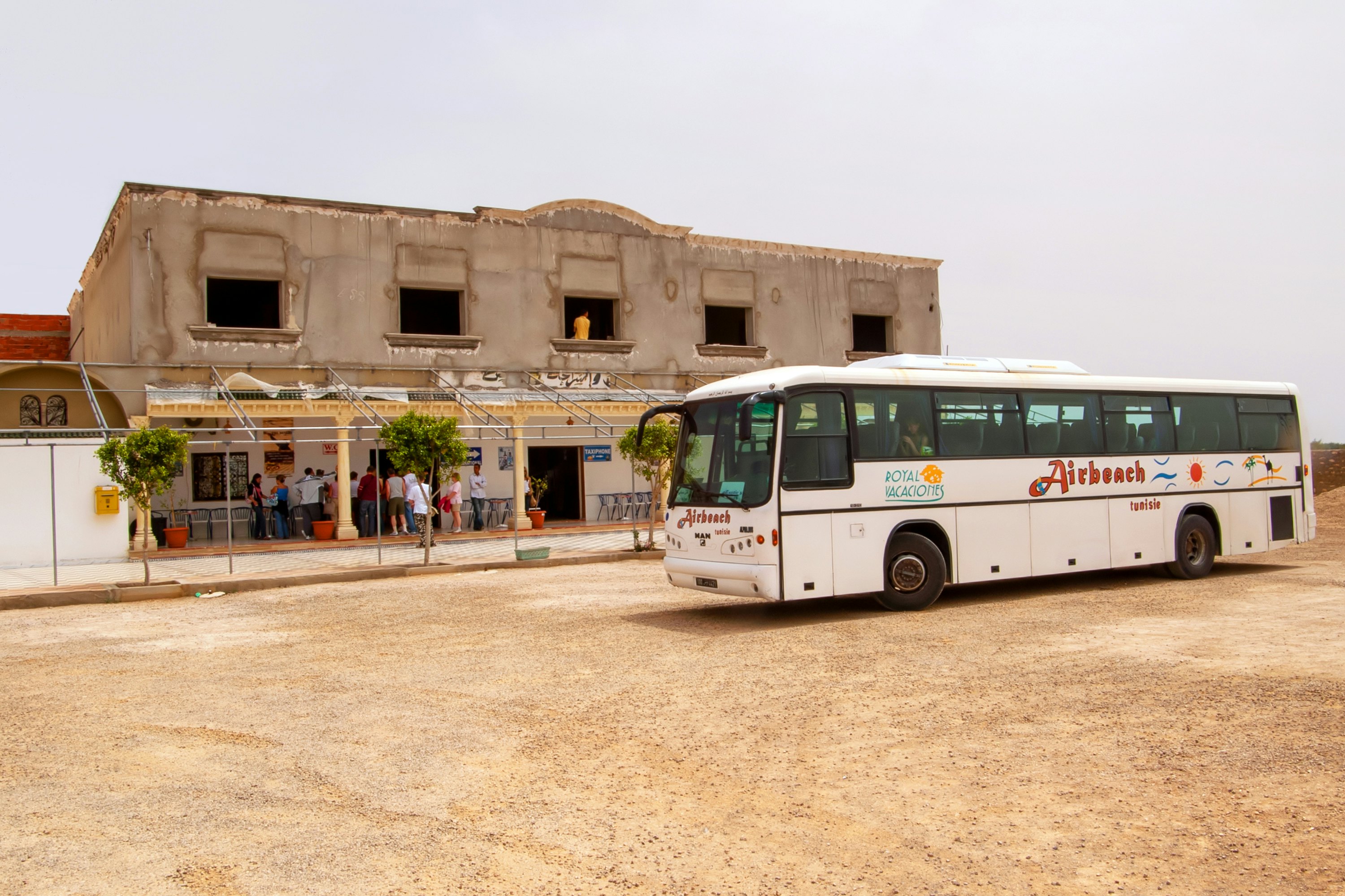 A tourist bus near a cafe in the Sahara desert, Tunisia.
