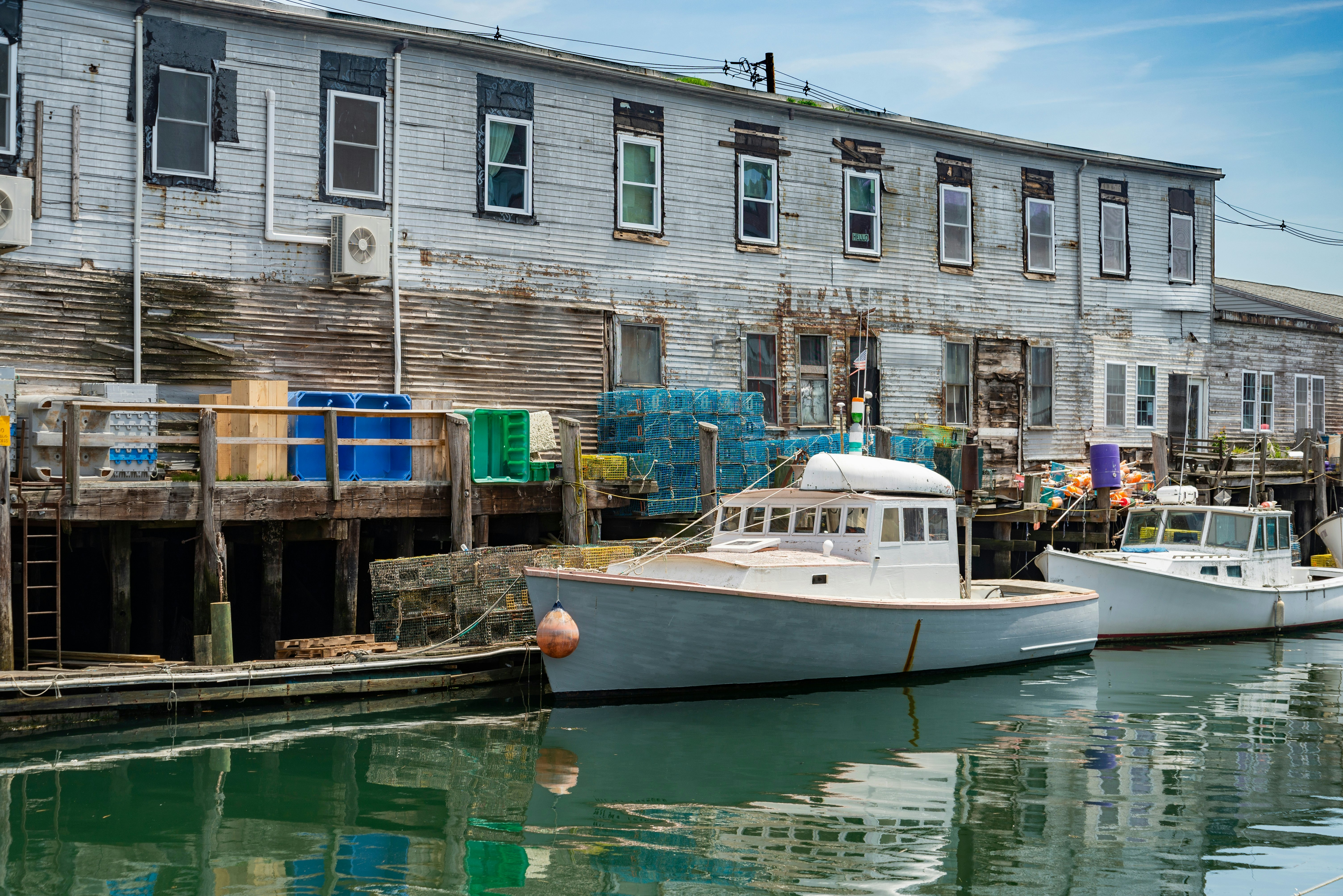 A pier filled with lobster traps and an old building, old port, in Portland, Maine.