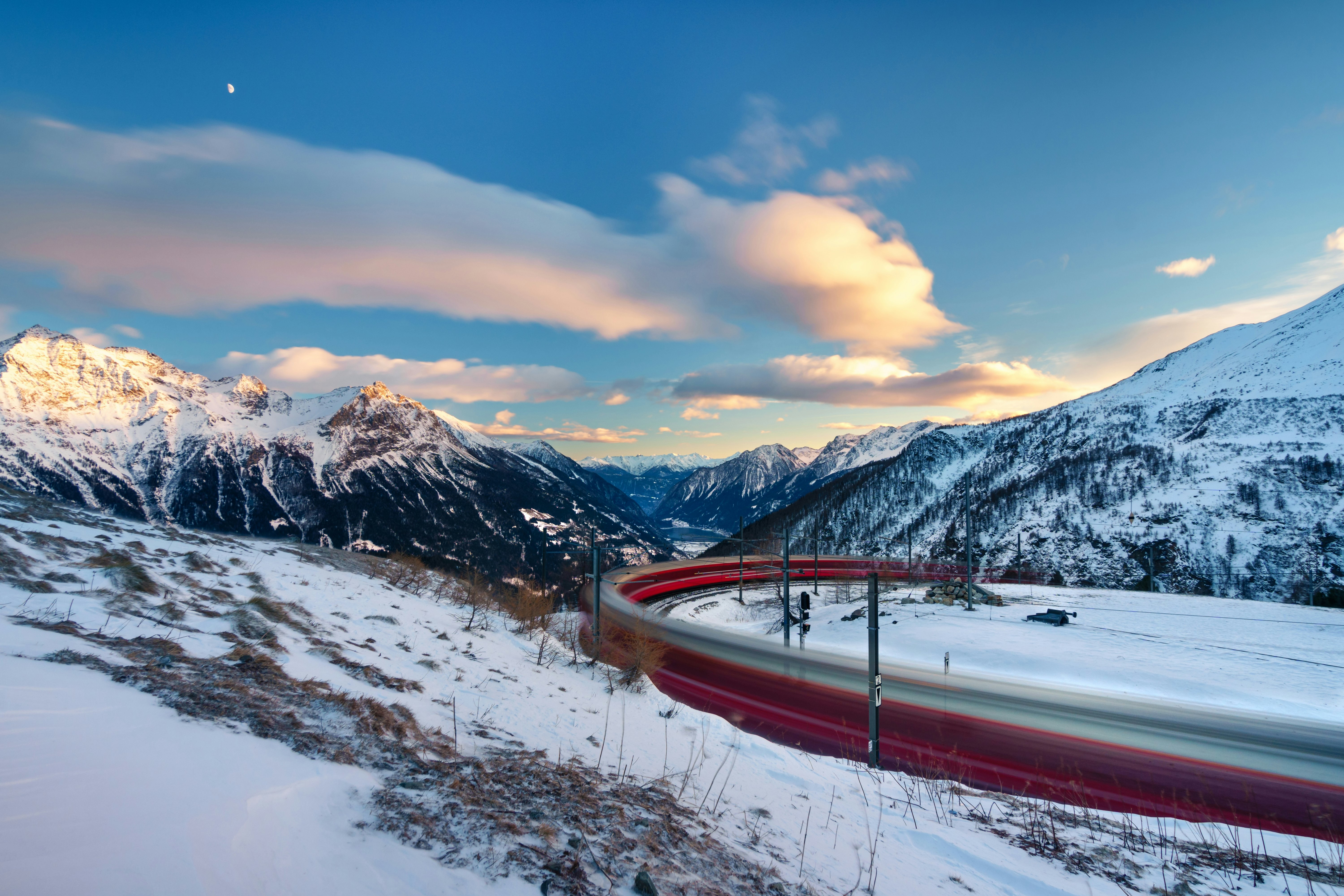 Long exposure view of Bernina Express as it passes through the railway station of Alp Grüm.