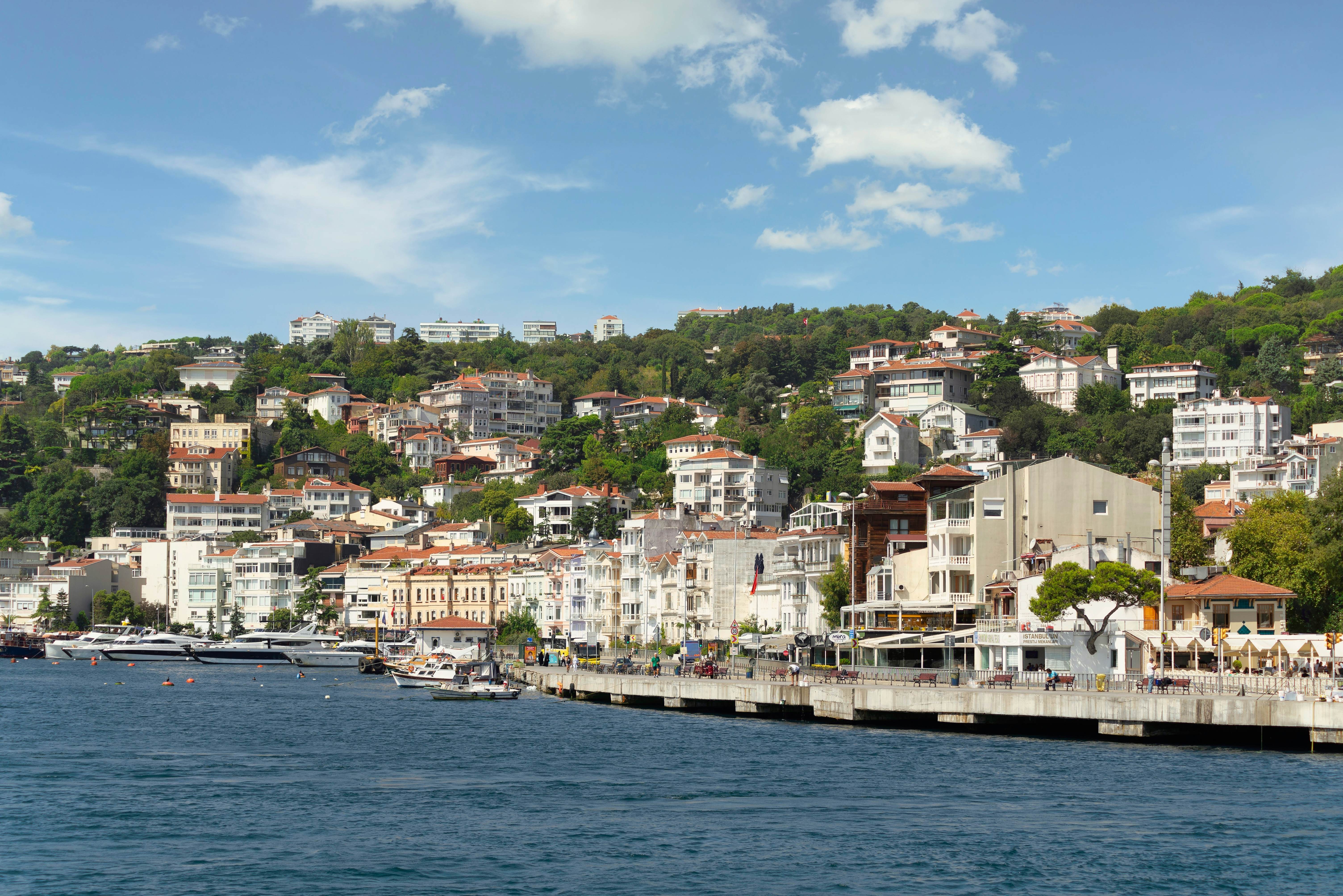 Istanbul, Turkey - August 29, 2022: Arnavutkoy, View from the sea of the green mountains of the Europian side of Bosphorus strait, with docked boats, traditional houses and dense trees in a summer day, License Type: media, Download Time: 2024-08-07T13:43:33.000Z, User: pinkjozie64, Editorial: true, purchase_order: 56530, job: Global Publishing WIP, client: Pocket Istanbul 7, other: Jo-anne RiddellJo-anne Riddell