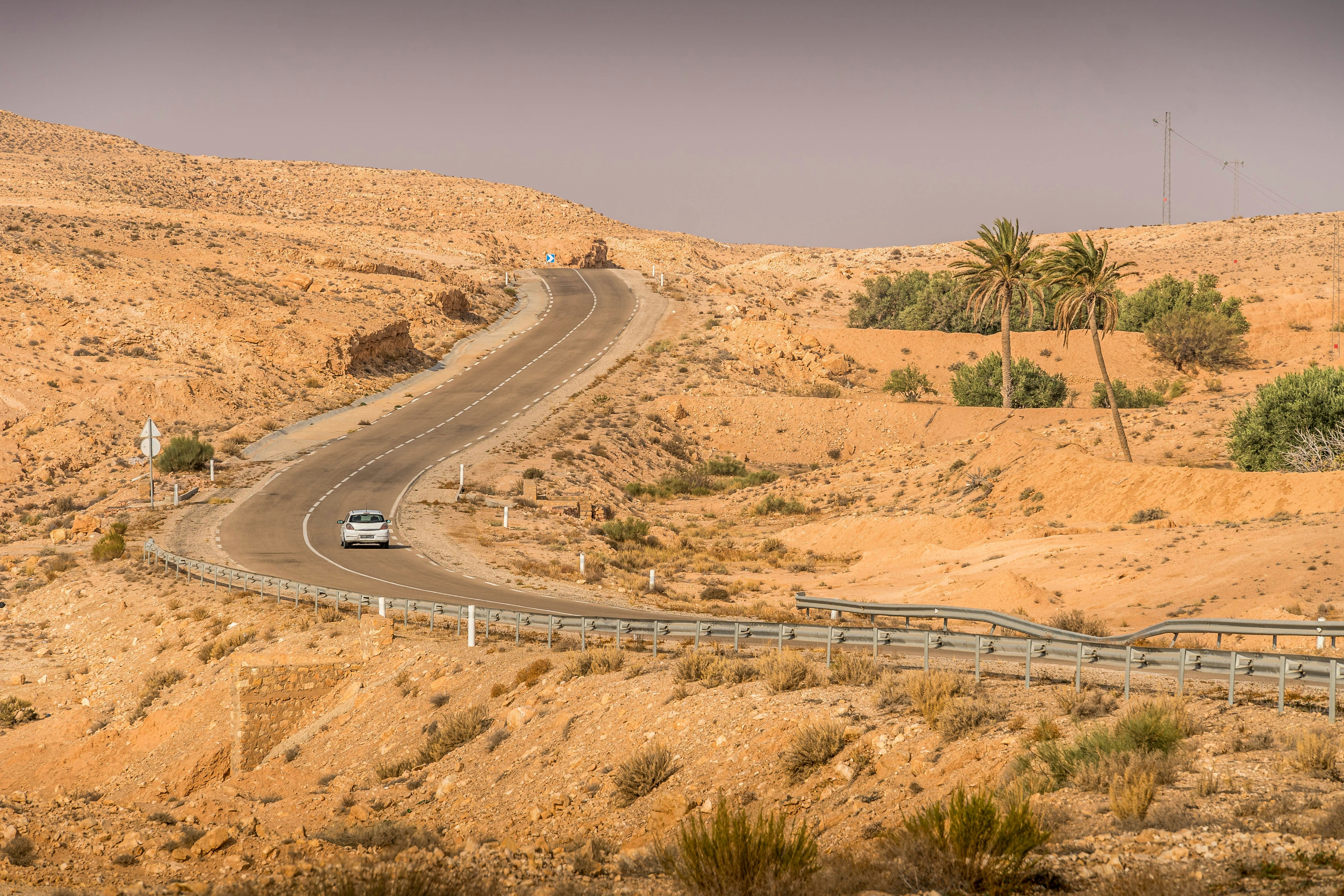 A car drives through the desert on the outskirts of Matmata, Tunisia.