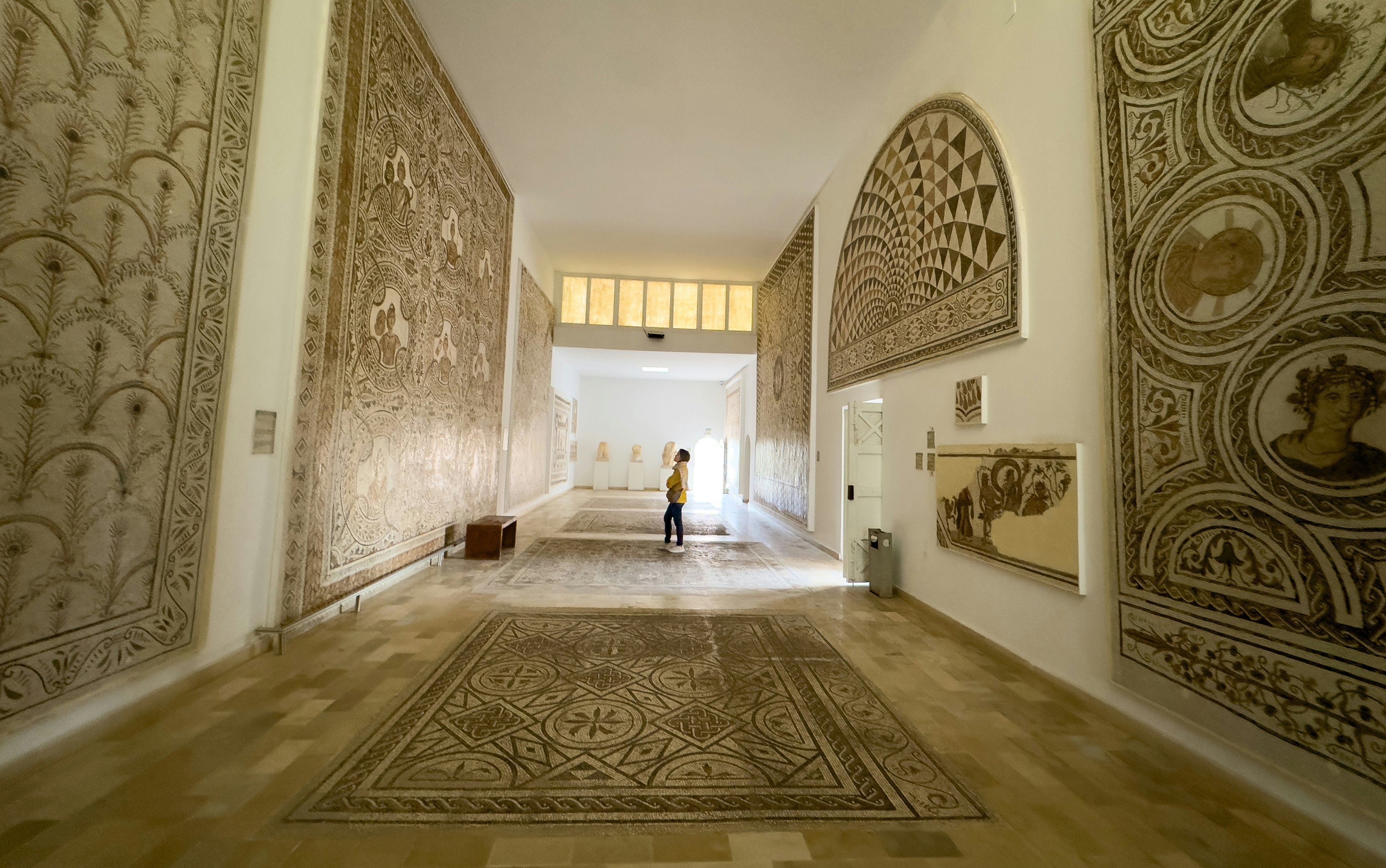 A visitor admires Roman mosaics in the El Jem Archaeological Museum, El Jem, Tunisia.