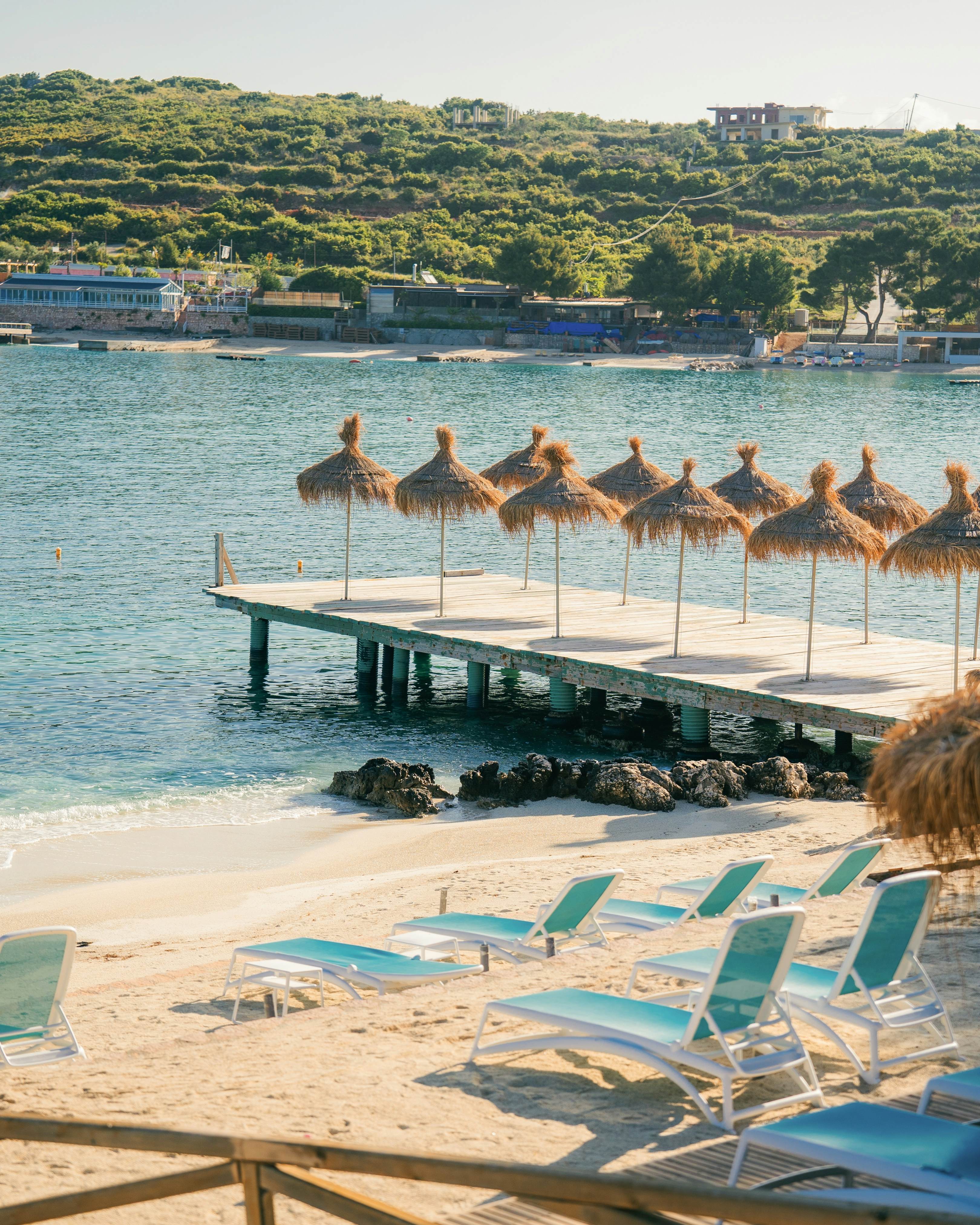 beach umbrellas with water in the background 