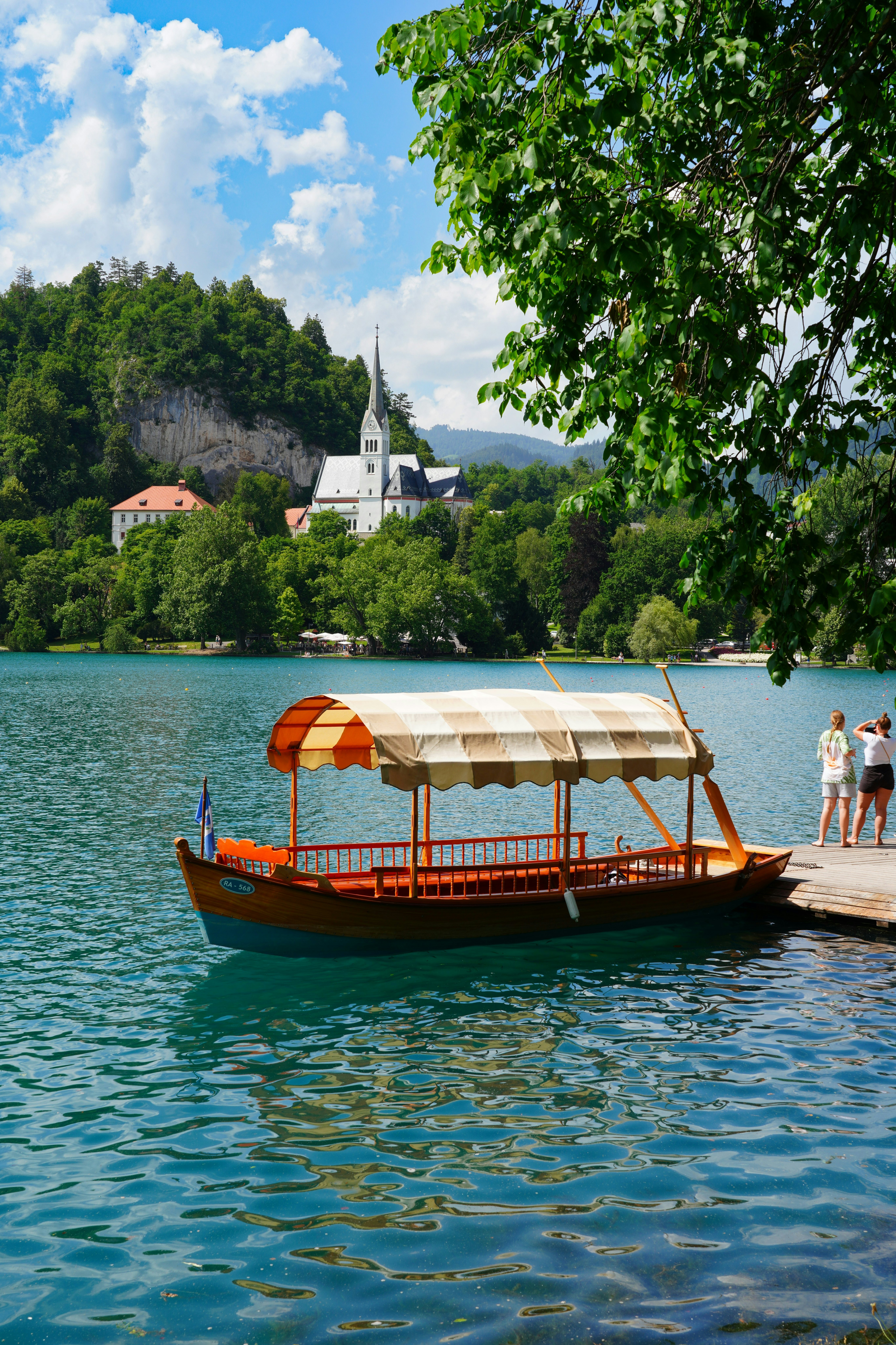 Pletna boat on Lake Bled in summer. Bled is a lake in the Julian Alps of the Upper Carniolan region of northwestern Slovenia with a castle on an island., License Type