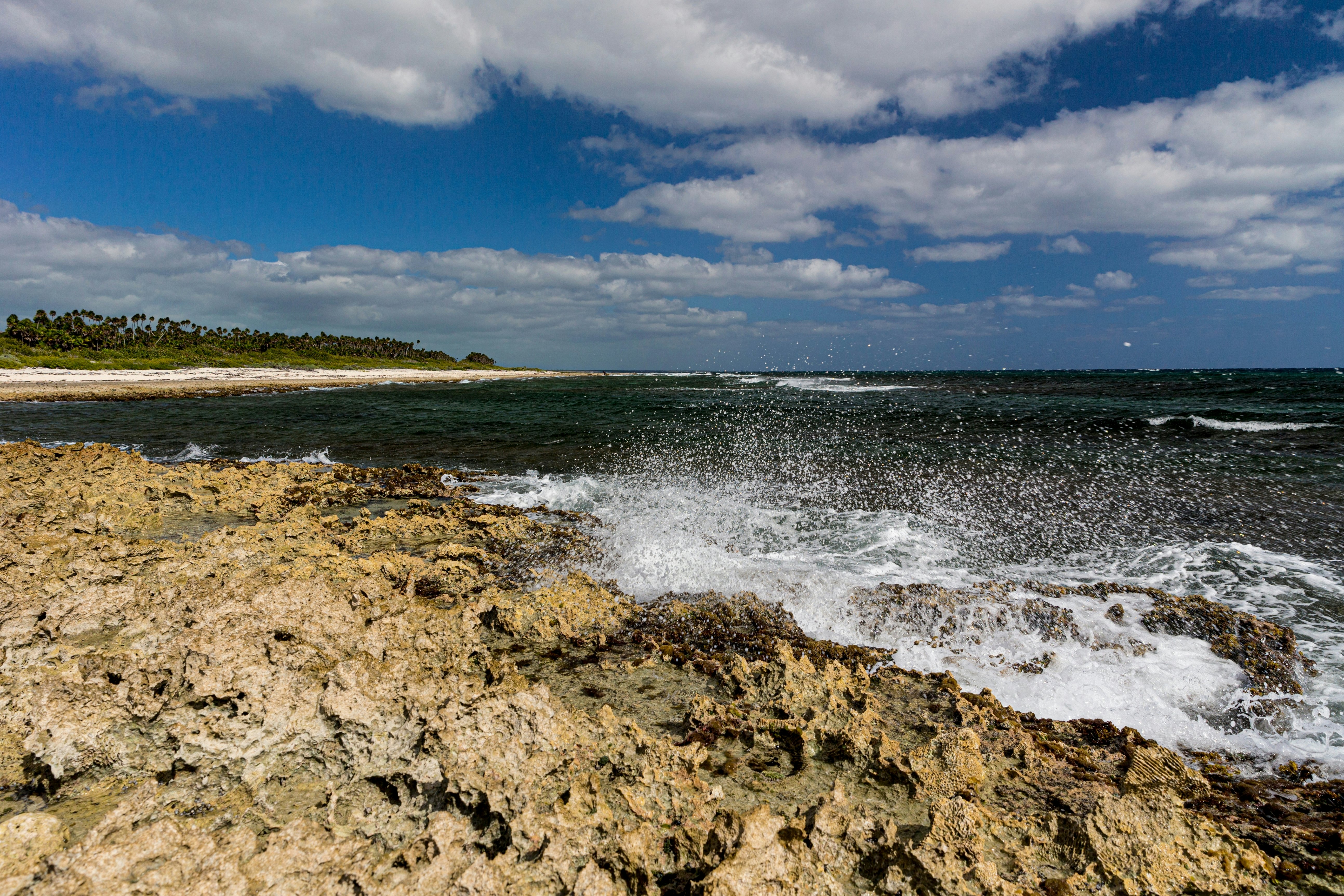 A wave crashes on a rocky shore in Cuba.