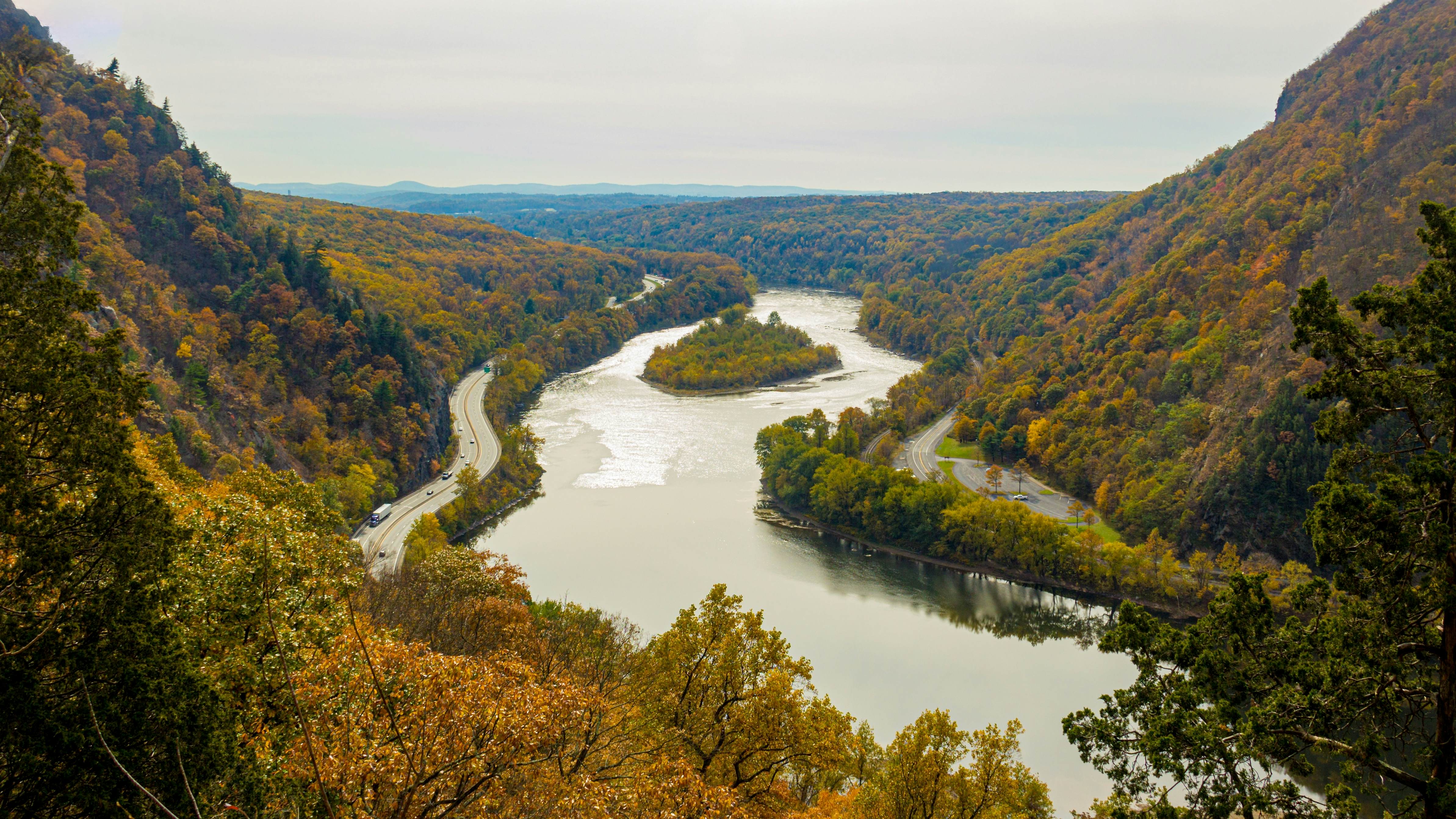 A breathtaking view from the summit of Mount Tammany, Delaware Water Gap, showcasing the Delaware River winding through vibrant autumn hillside forests under a cloudy sky., License Type: media, Download Time: 2025-05-28T09:21:56.000Z, User: lonelyplanetmedia, Editorial: false, purchase_order: 65050 - Digital Destinations and Articles, job: Global Publishing WIP, client: Global Publishing WIP, other: Peterson Haggarty // SS Comp Ingestion