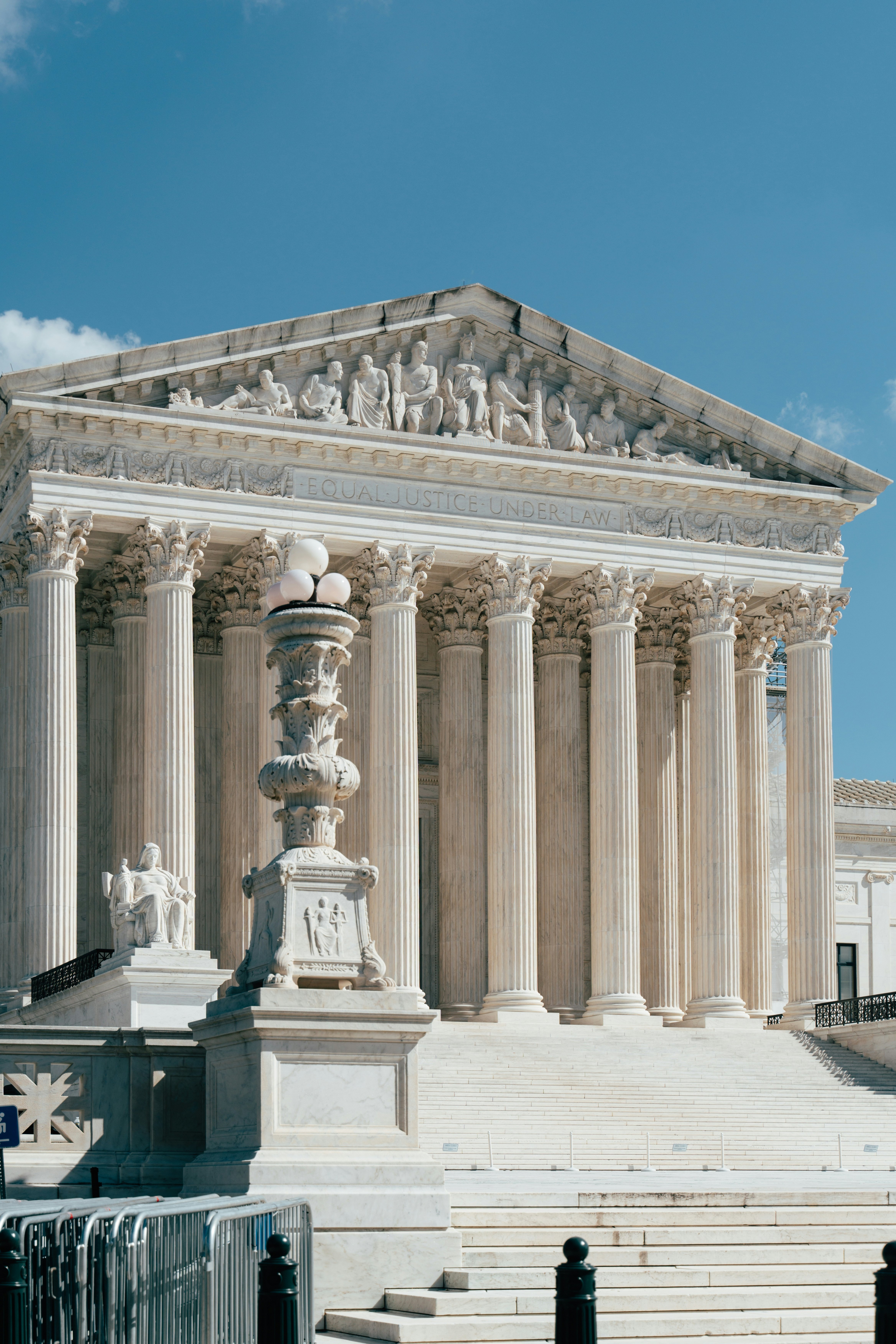 Supreme Court building in D.C. designed in Neoclassical style, resembling a Greek temple with its grand columns and pediment
