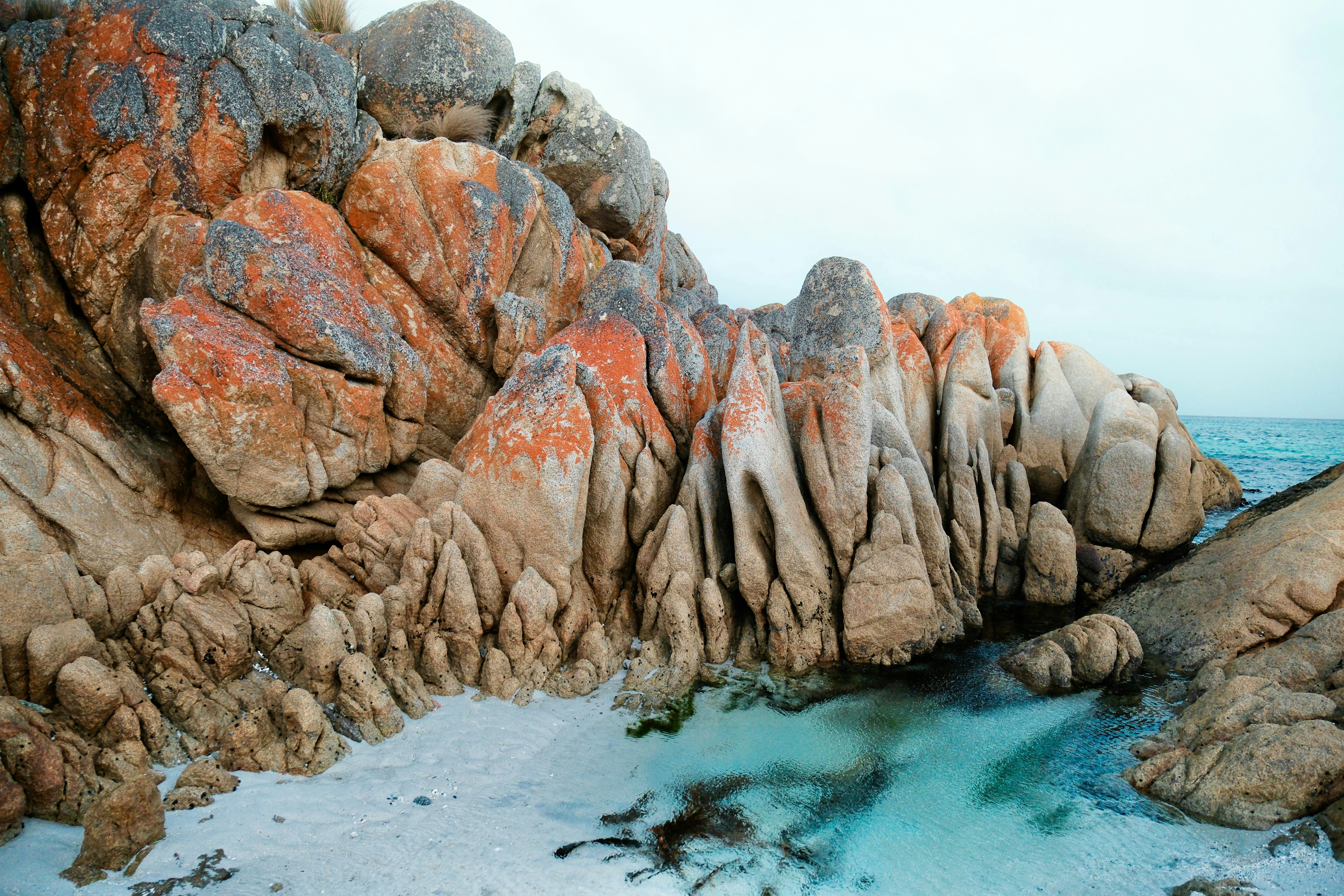 Rocks with red on top and water