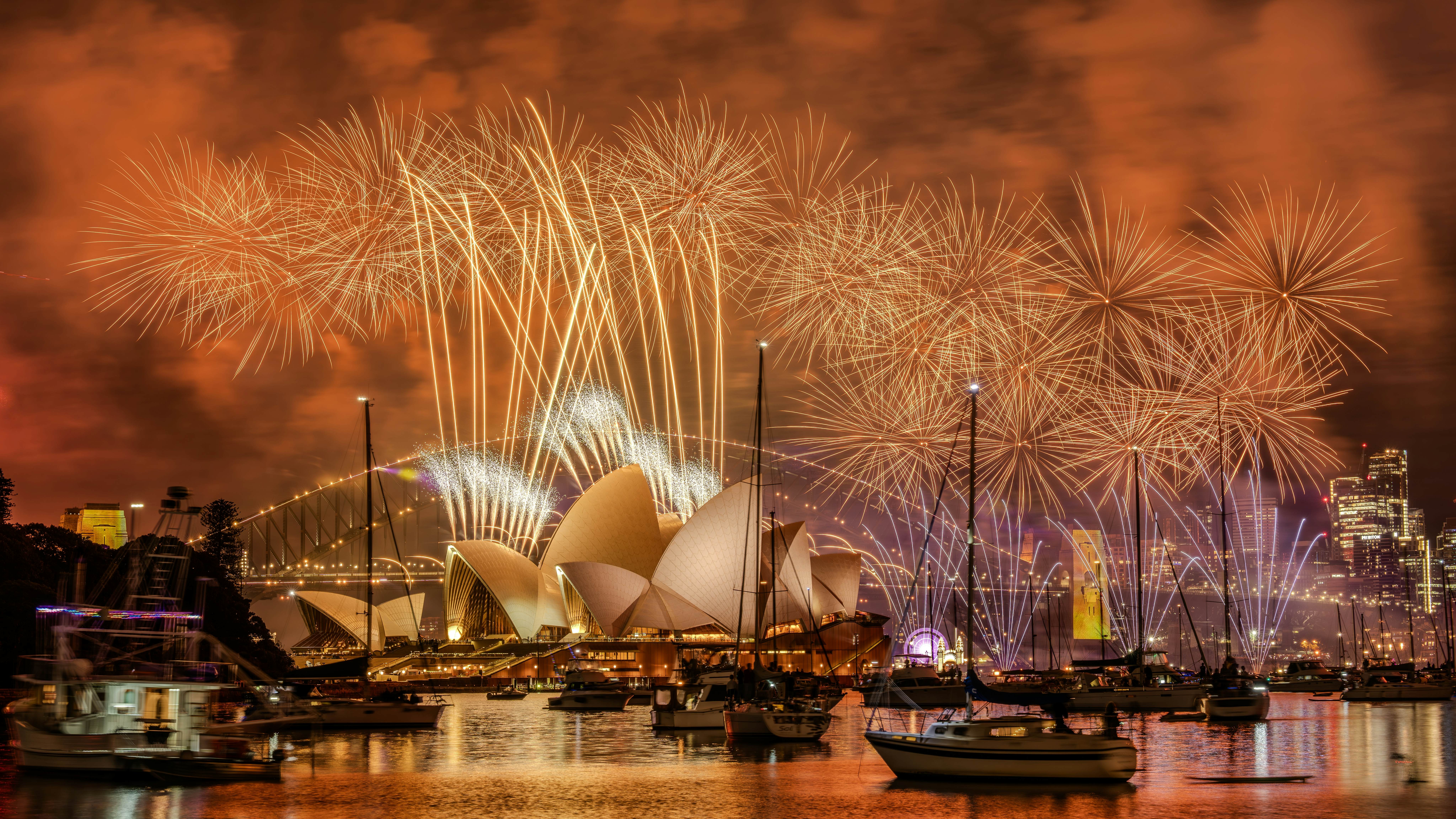 Sydney, NSW, Australia – Dec 31, 2024: Fireworks light the night over Sydney Harbour, with the Opera House and Harbour Bridge aglow. Calm waters reflect vibrant colors and nearby luxury boats., License Type: media, Download Time: 2025-12-03T09:59:36.000Z, User: sashabrady26, Editorial: true, purchase_order: 65050 - Digital Destinations and Articles, job: Lonely Planet, client: Best time to visit Sydney, other: Sasha Brady