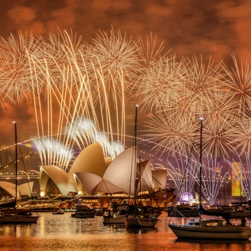 Sydney, NSW, Australia – Dec 31, 2024: Fireworks light the night over Sydney Harbour, with the Opera House and Harbour Bridge aglow. Calm waters reflect vibrant colors and nearby luxury boats., License Type: media, Download Time: 2025-12-03T09:59:36.000Z, User: sashabrady26, Editorial: true, purchase_order: 65050 - Digital Destinations and Articles, job: Lonely Planet, client: Best time to visit Sydney, other: Sasha Brady