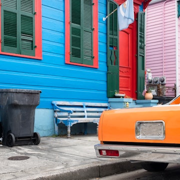 New Orleans colorful vintage painted houses and a classic orange car parked in front. Typical shotgun architectural style of homes seen in the historic neighborhoods., License Type: media, Download Time: 2025-05-29T14:40:52.000Z, User: lonelyplanetmedia, Editorial: false, purchase_order: 65050 - Digital Destinations and Articles, job: Global Publishing WIP, client: Global Publishing WIP, other: Peterson Haggarty // SS Comp Ingestion