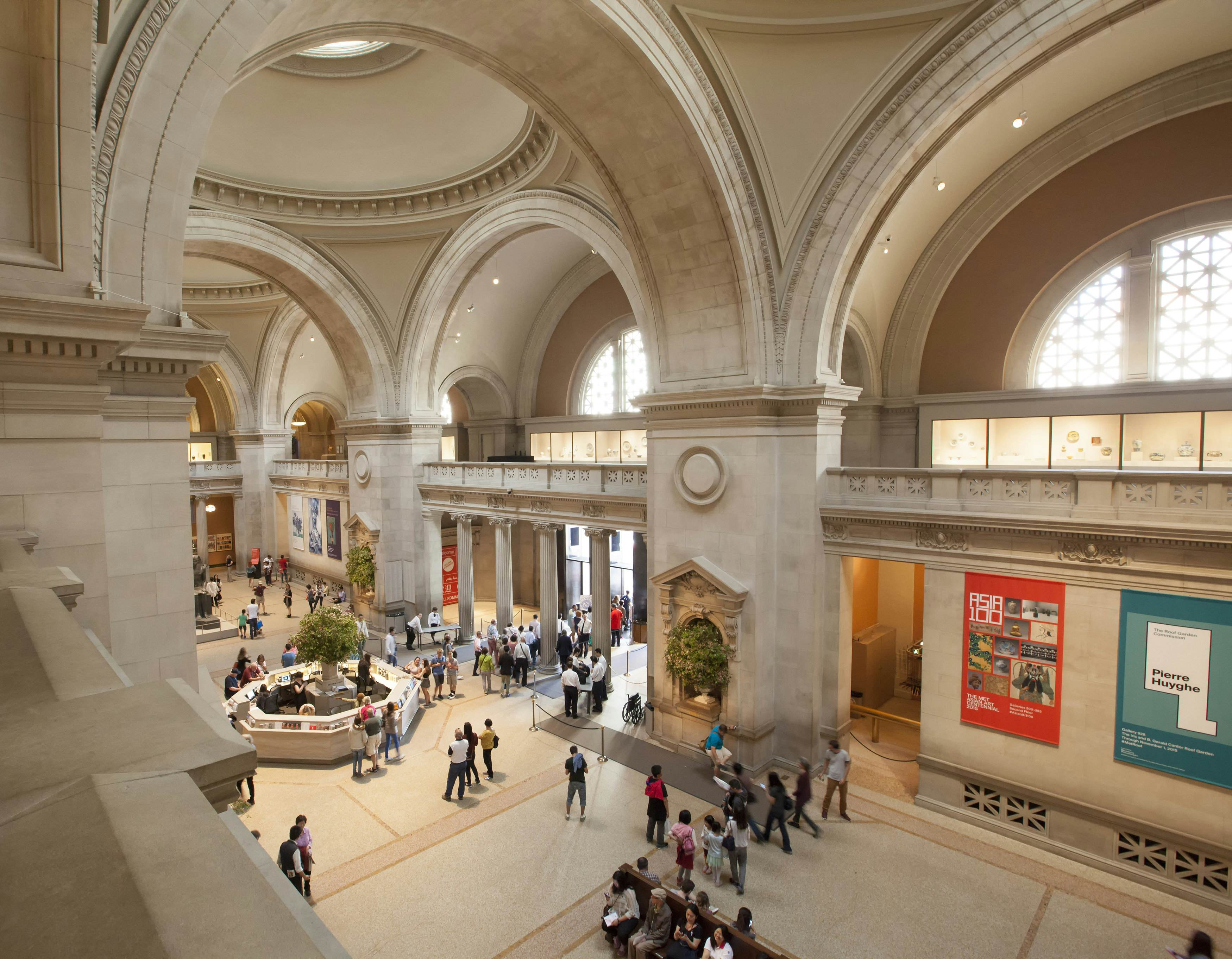 A view of a huge hall in a beaux-art-style museum building.