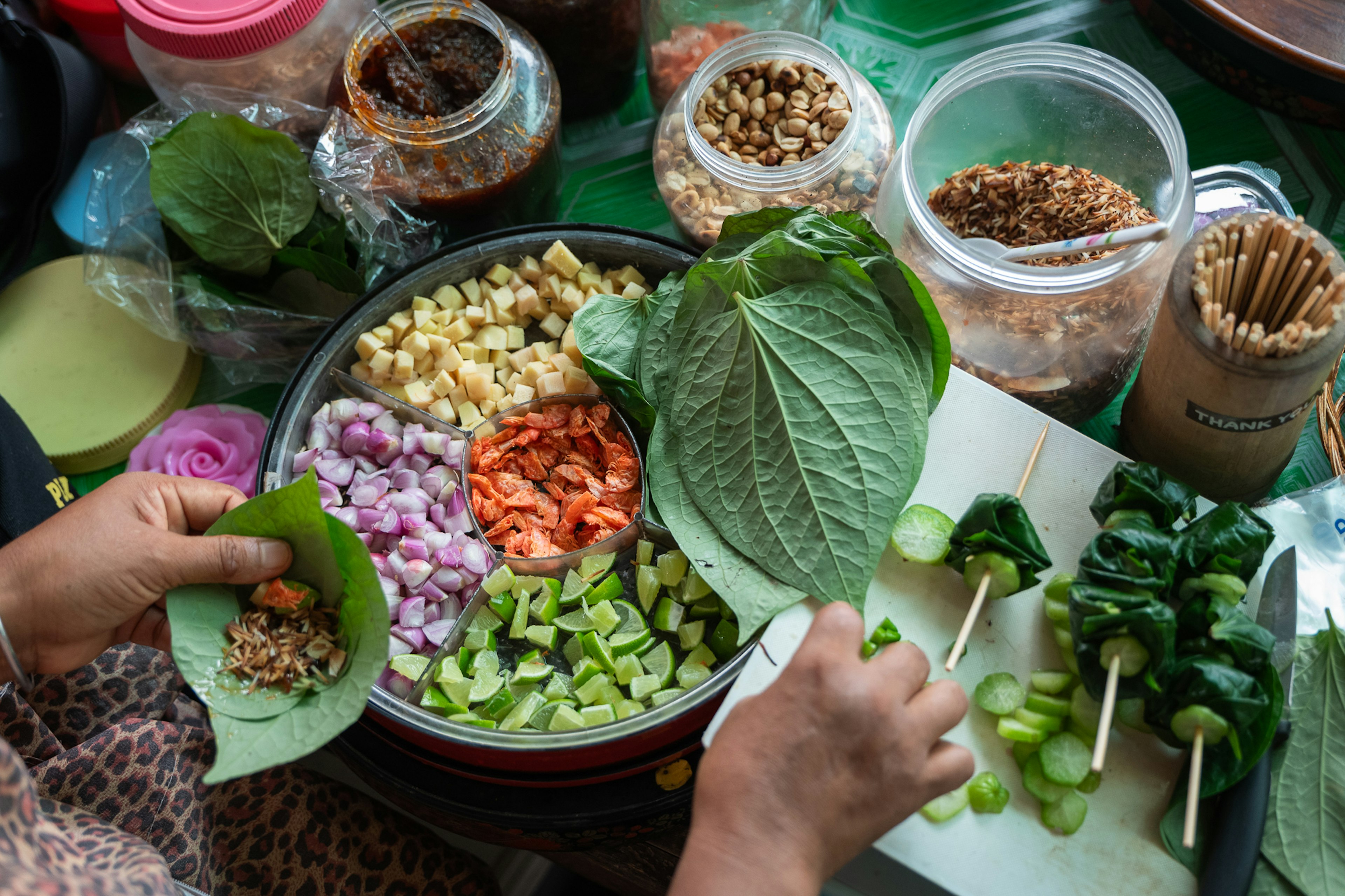A person prepares a sweet-savory snack from multiple ingredients.