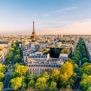 GettyImages-2197457906.jpg
Paris cityscape with Eiffel Tower and green trees on a sunny summer day, high angle view, France