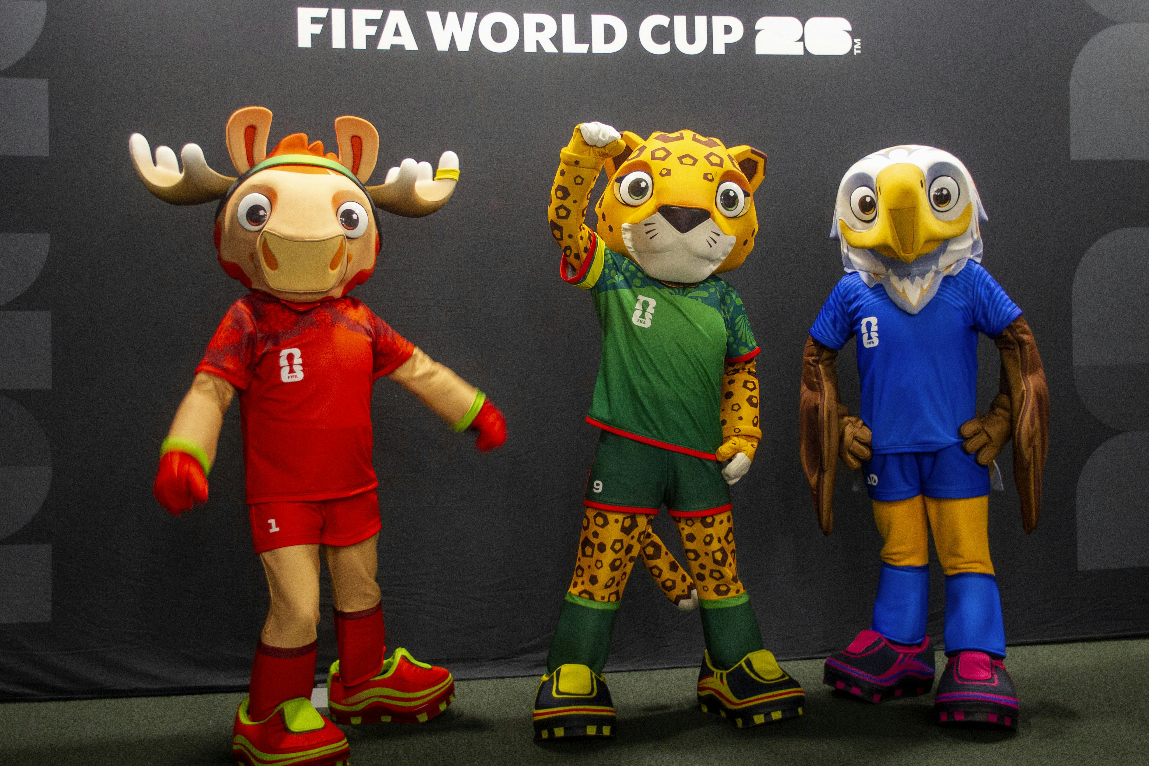 Sports mascots of moose, a jaguar and a bald eagle all wear soccer cleats.