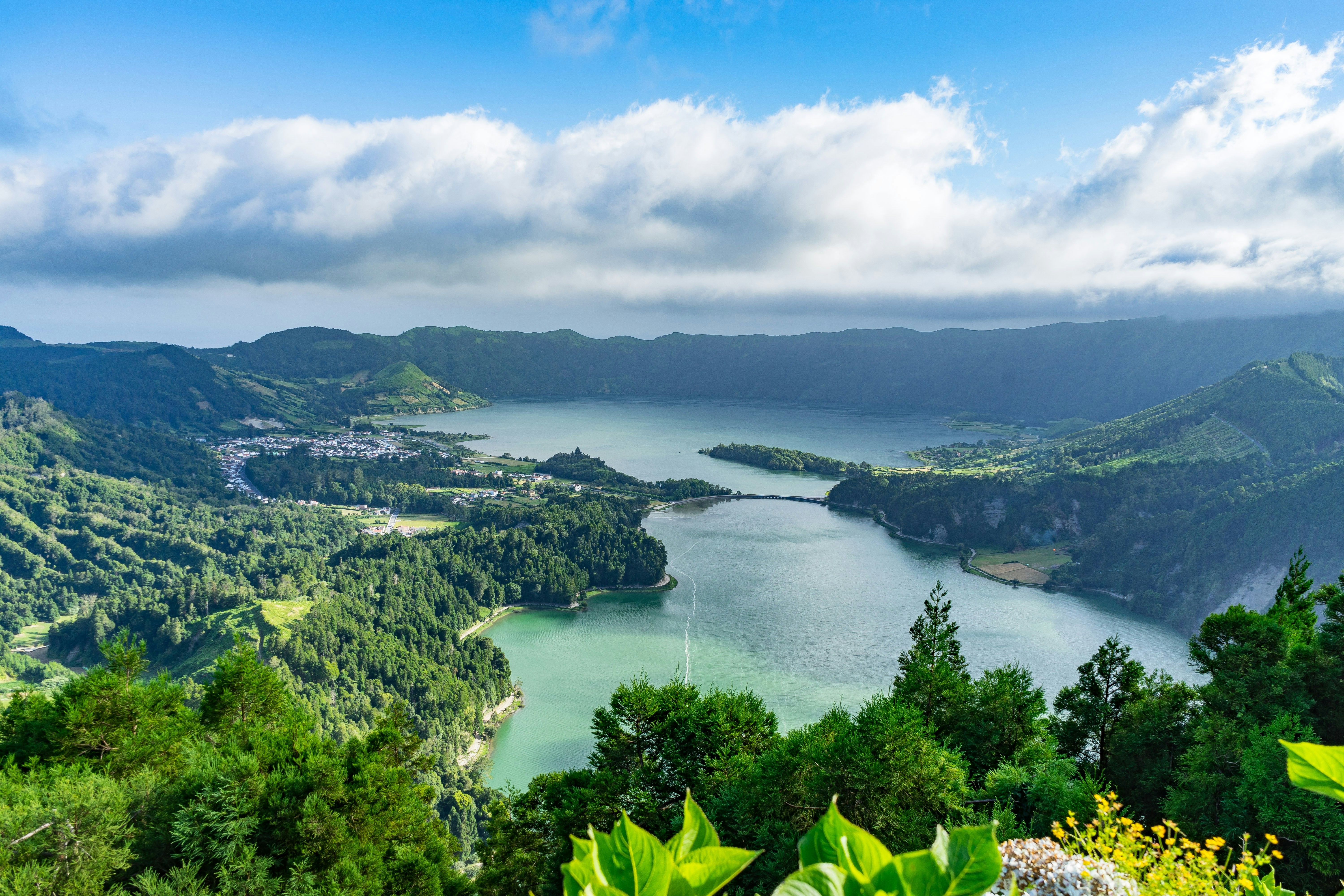 A lush caldera with two central lakes surrounded by woodland.