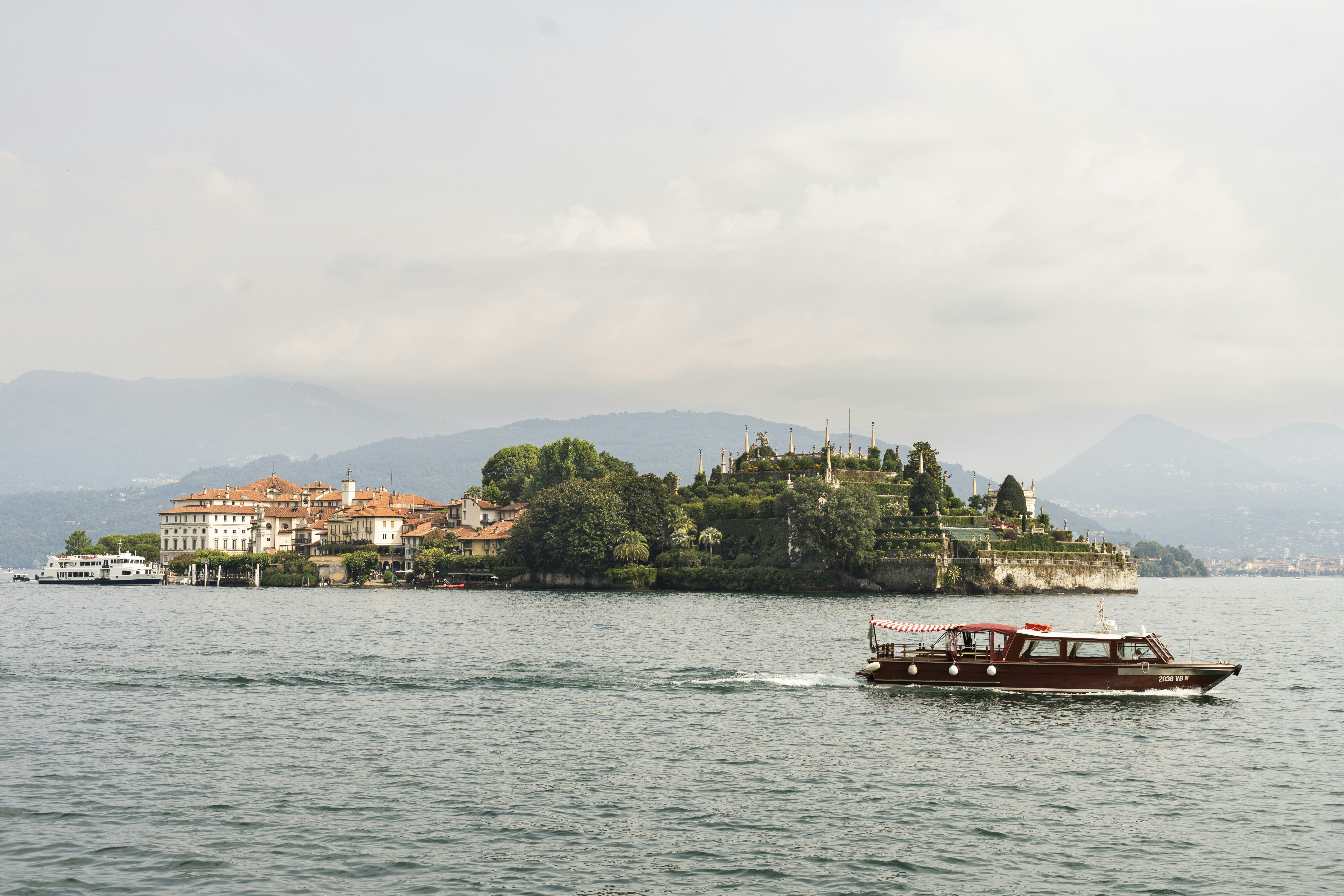 A passenger boat passes Isola Bella in Lake Maggiore, Italy.