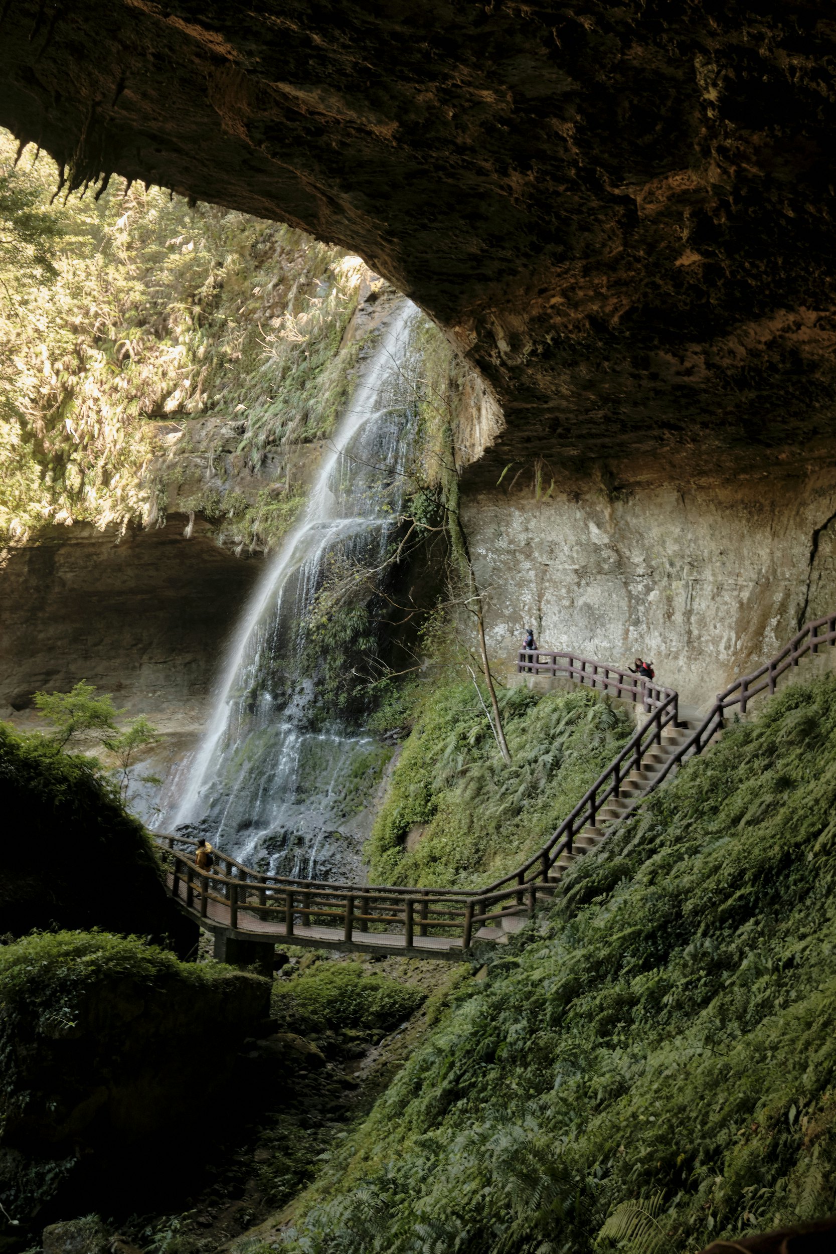People walking on a bridge at the Songlong Rock Waterfall near the Shanlinhsi (Shanlinxi) Nature Park